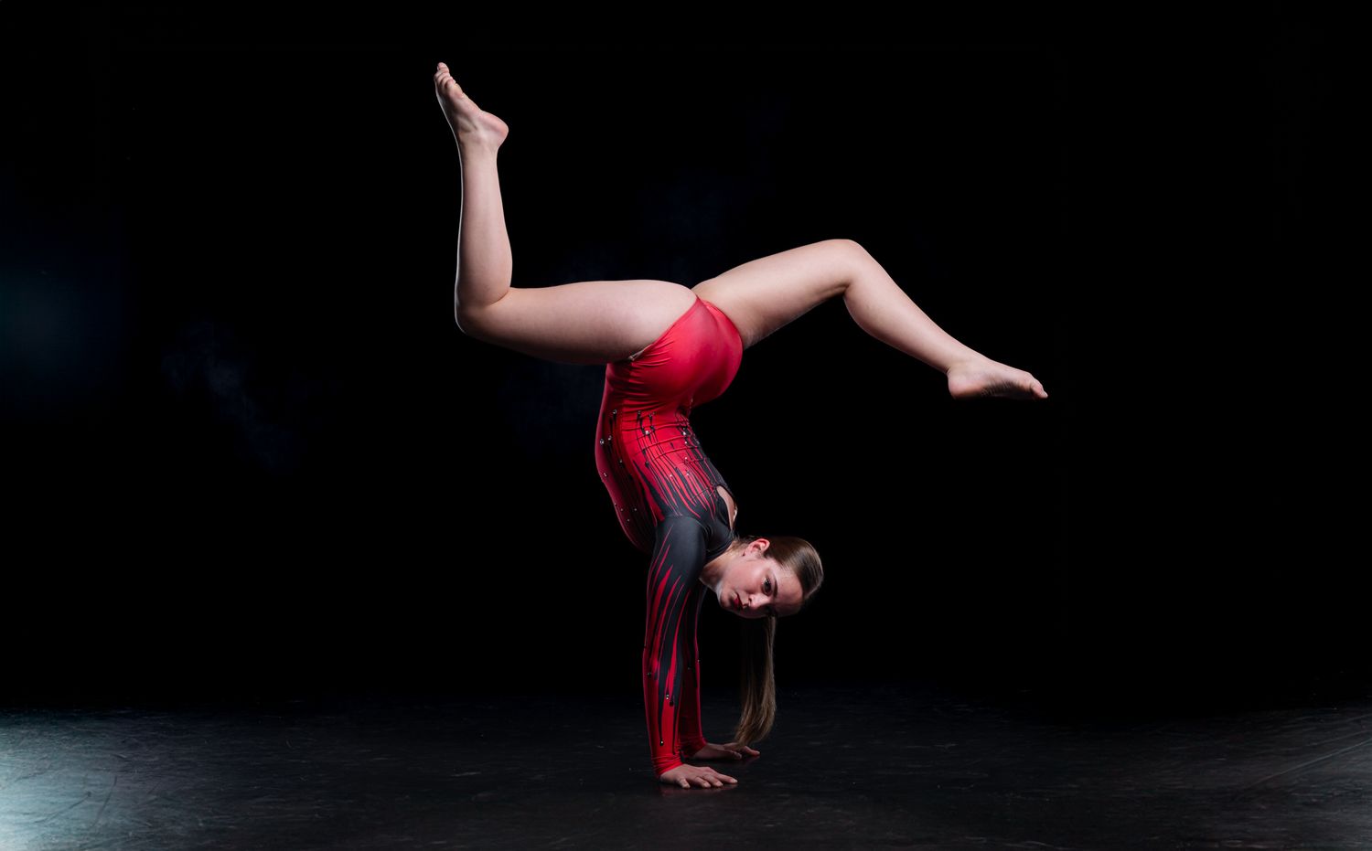 Technical dance school portrait of a student in a technical and polished pose, emphasizing clean lines and professional studio lighting