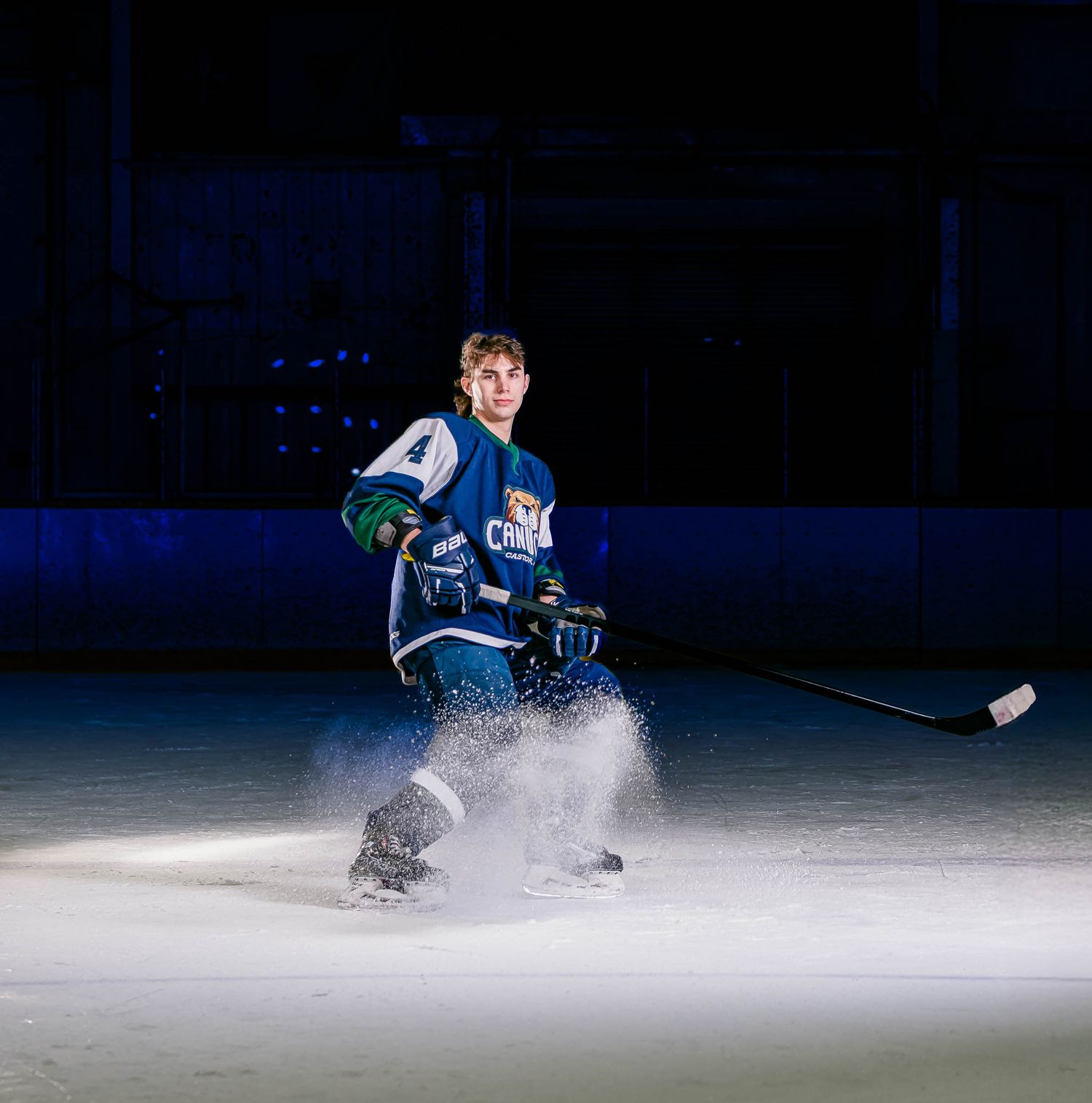 Elite hockey team media day portrait with dramatic lighting and on-ice smoke effects in Eastern Ontario by The Show Sports Media