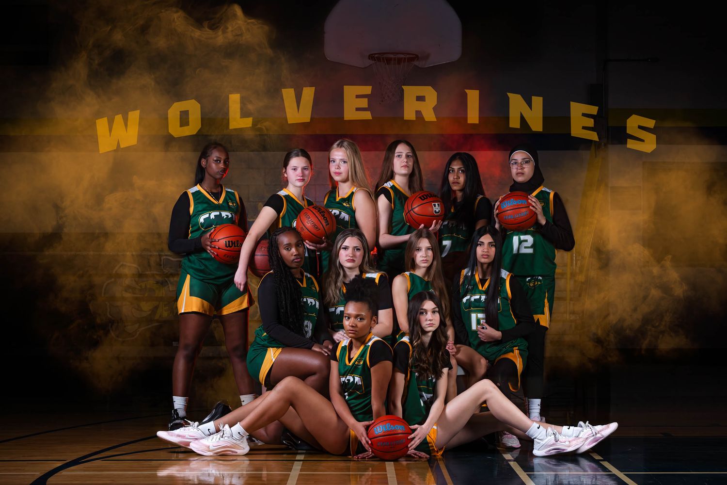 Team media day graphic by The Show Sports Media displaying a girls basketball squad with gold Wolverines text overlay and fog details