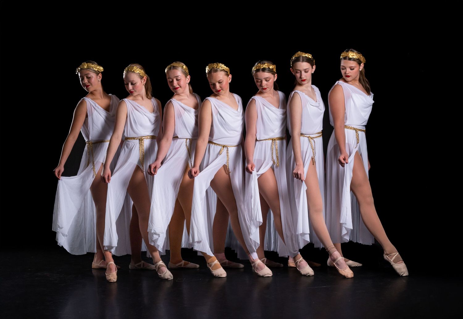 A clean, elegant lineup of a competitive Ottawa dance squad standing shoulder-to-shoulder in matching costumes.