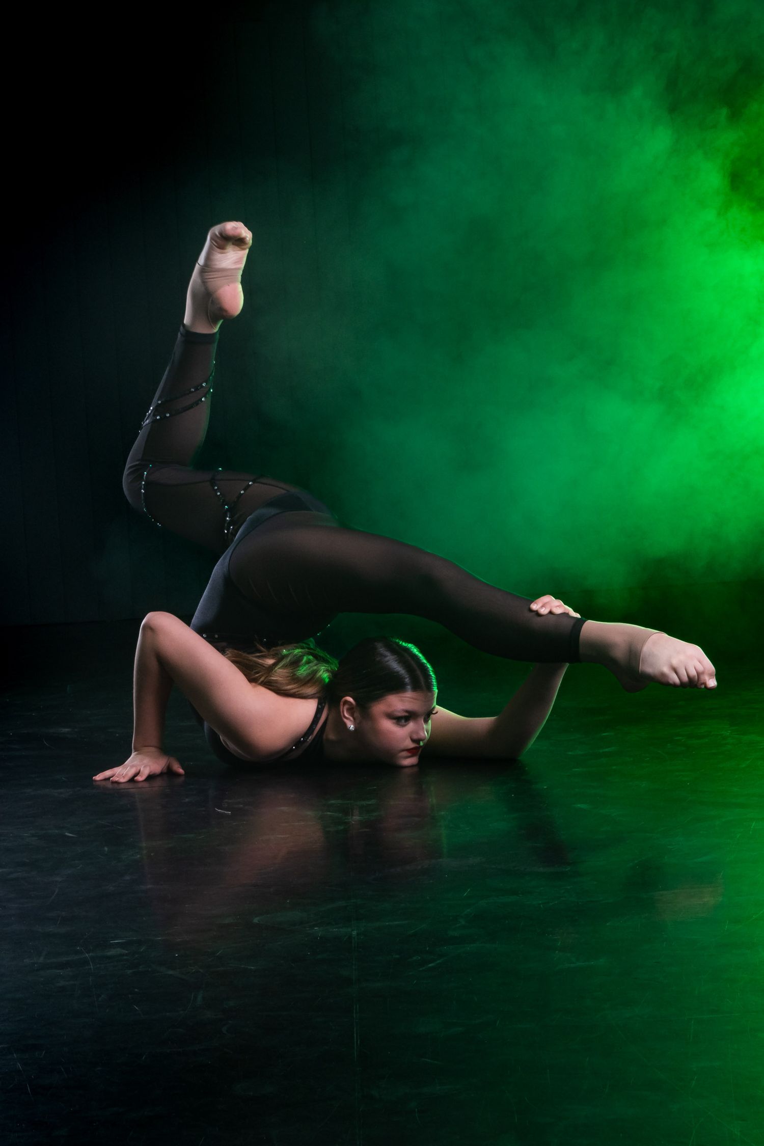 A professional-grade Acro dance school portrait with smoke effects, focusing on artistic excellence and technical precision
