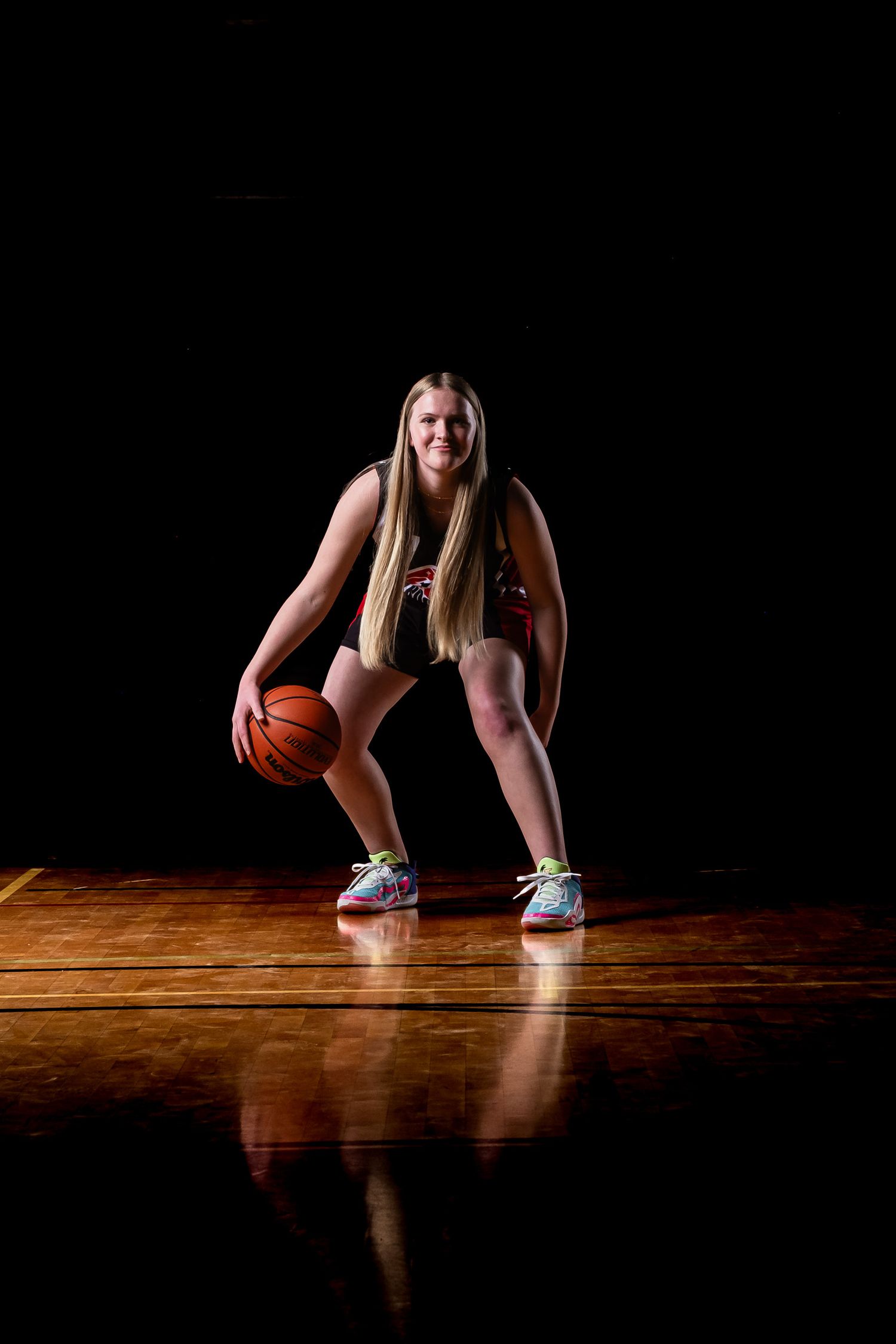 Sports portrait of a basketball athlete using in dramatic lighting bouncing the ball