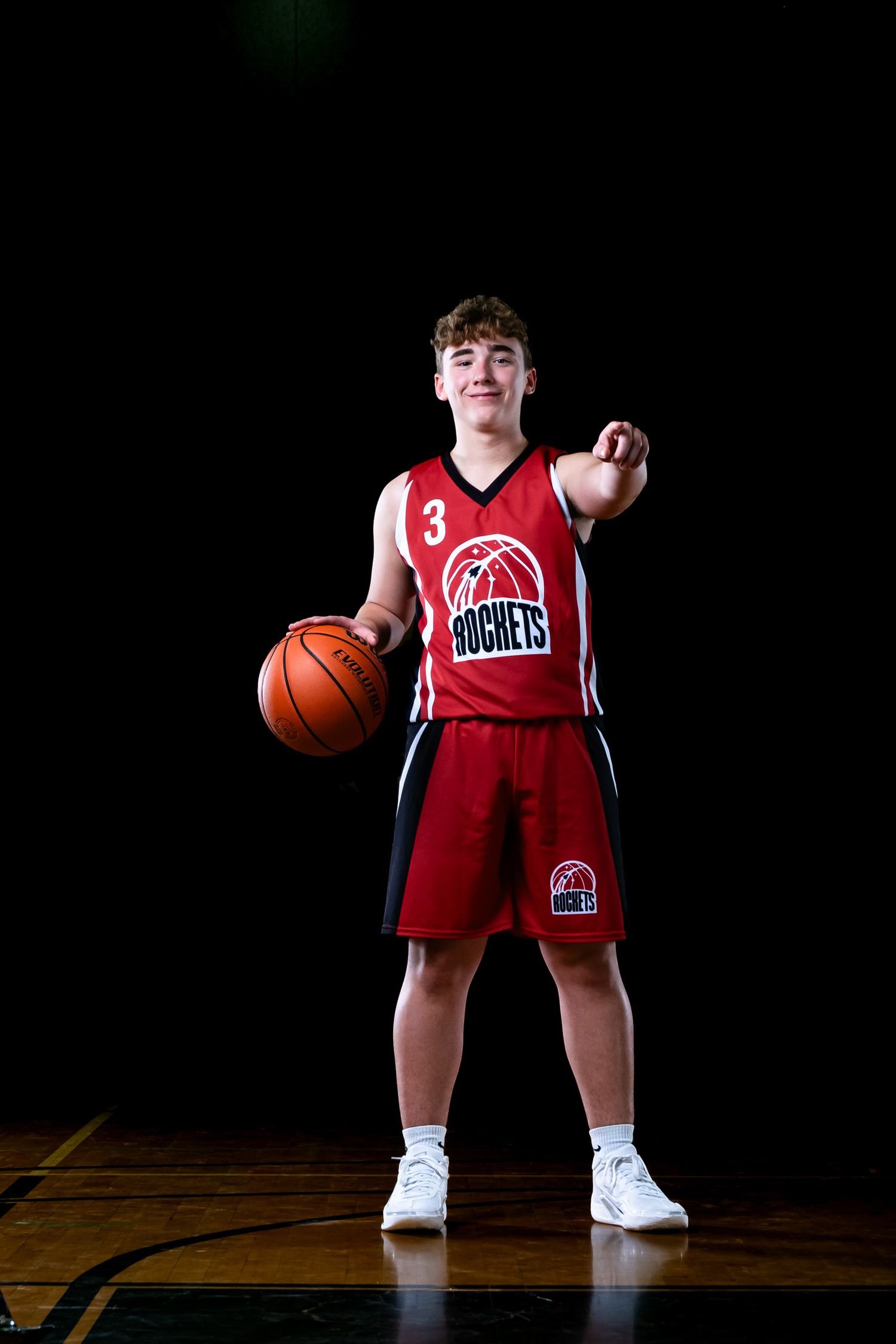 Ottawa sports photography media day feature showing a moody, cinematic portrait of a basketball player pointing at the camera