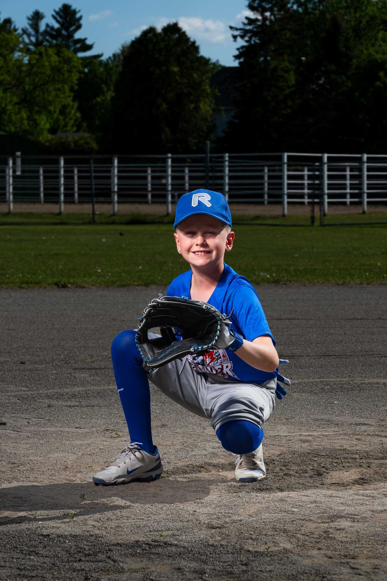 baseball player on the diamond with glove out waiting to catch a ball