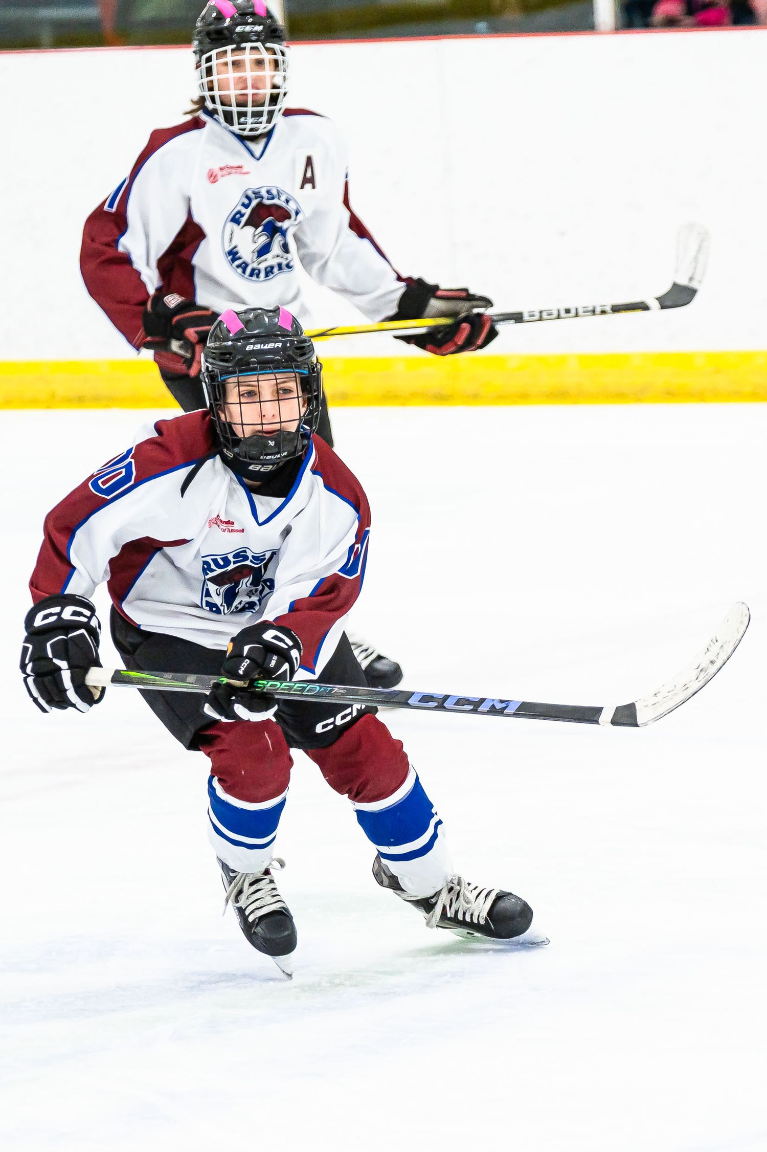High-intensity two player hockey action shot during a live game in Russell