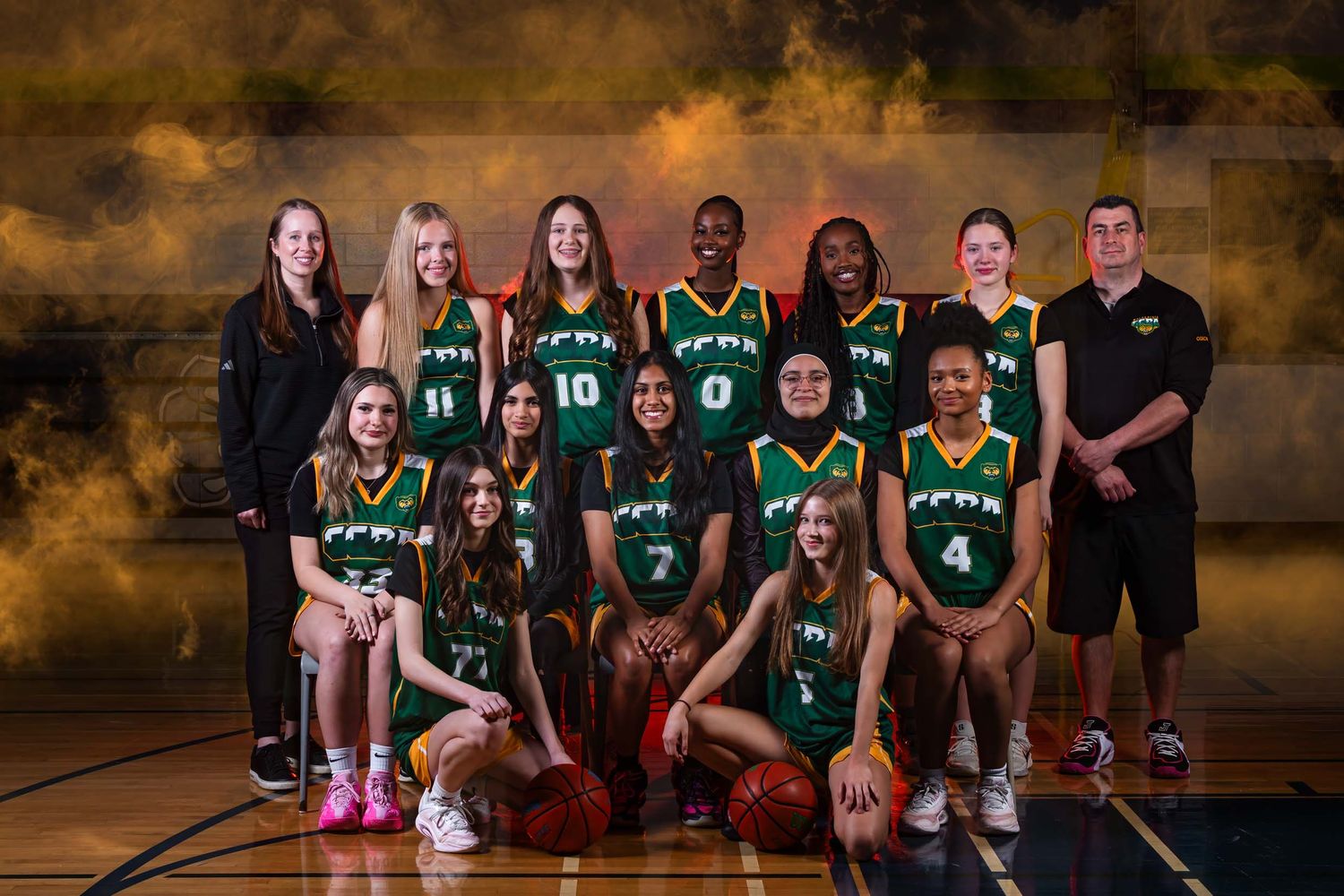 Full group portrait of the Ottawa Wolverines basketball team and coaching staff with premium arena graphics