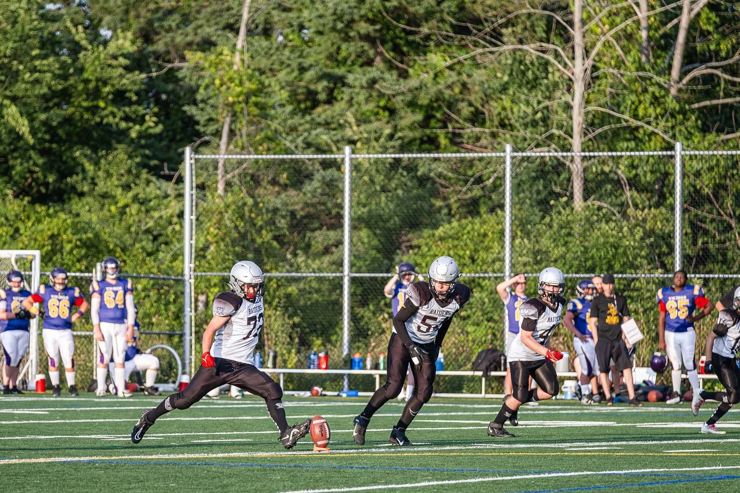 Action shot of  Ottawa youth kicker about to kick the football