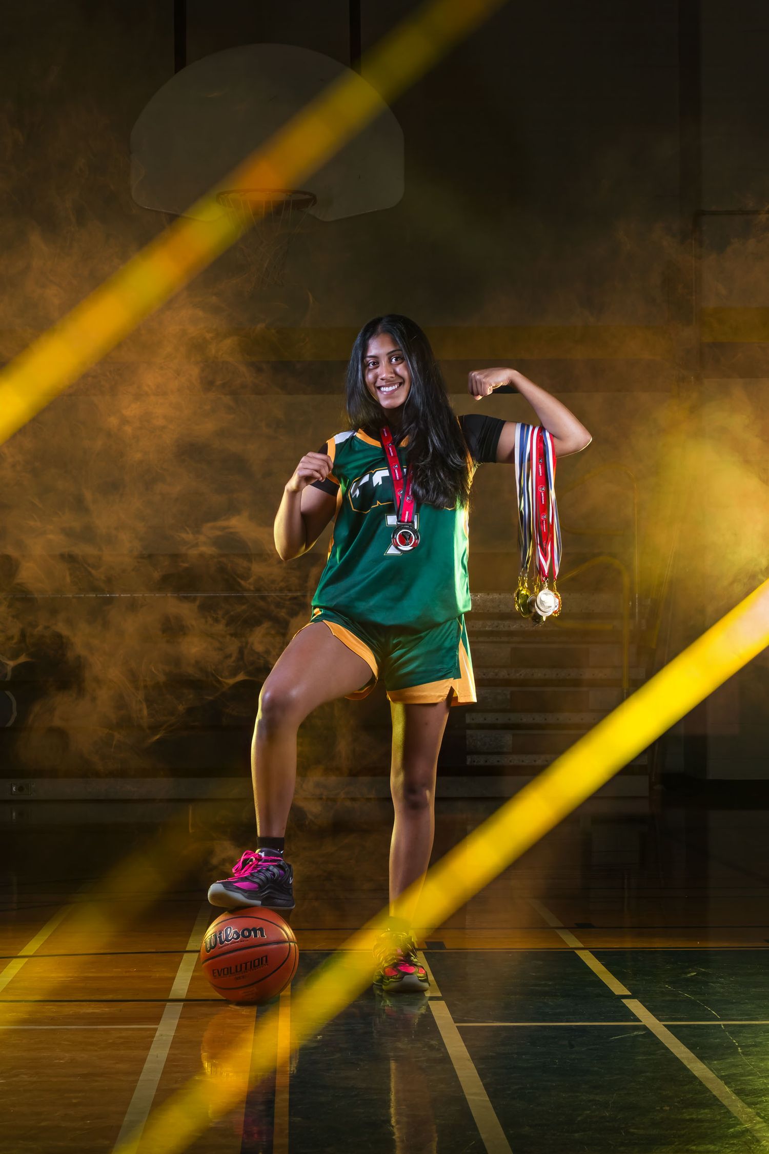Creative sports media day graphics showcasing a basketball player with high-impact gold lighting.