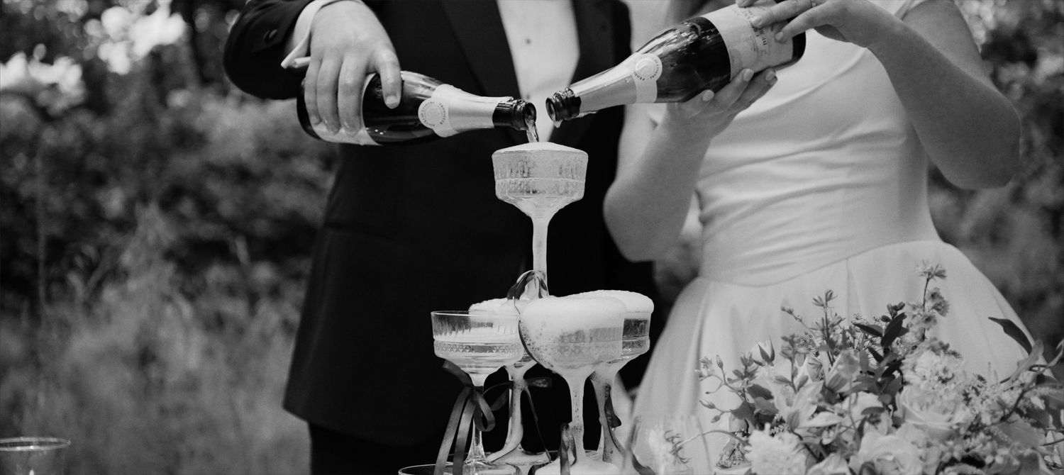 Editorial black tie champagne tower pour at luxury UK cotswolds wedding