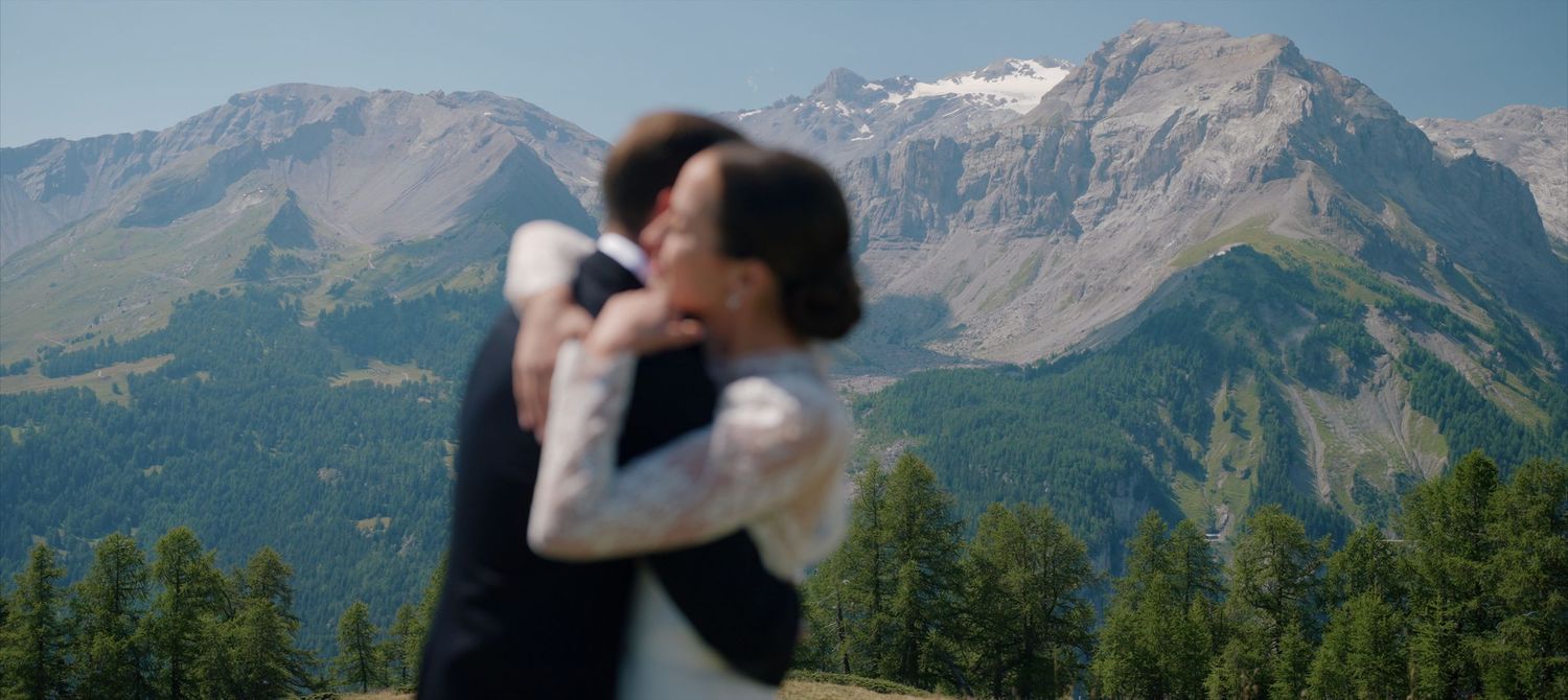 A scenic mountain wedding ceremony with snow-capped peaks and evergreen forests providing a majestic backdrop.