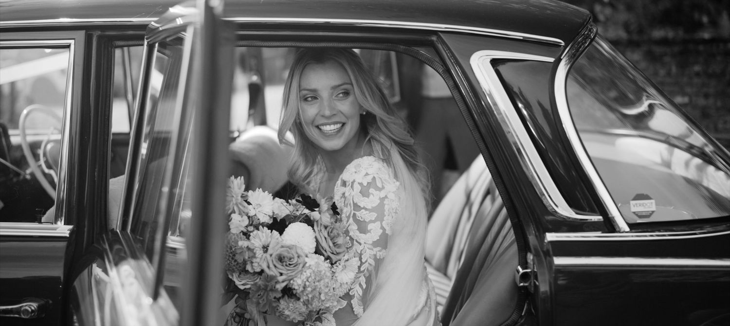 Bride arriving by car for an elegant Cornwell Manor church wedding ceremony