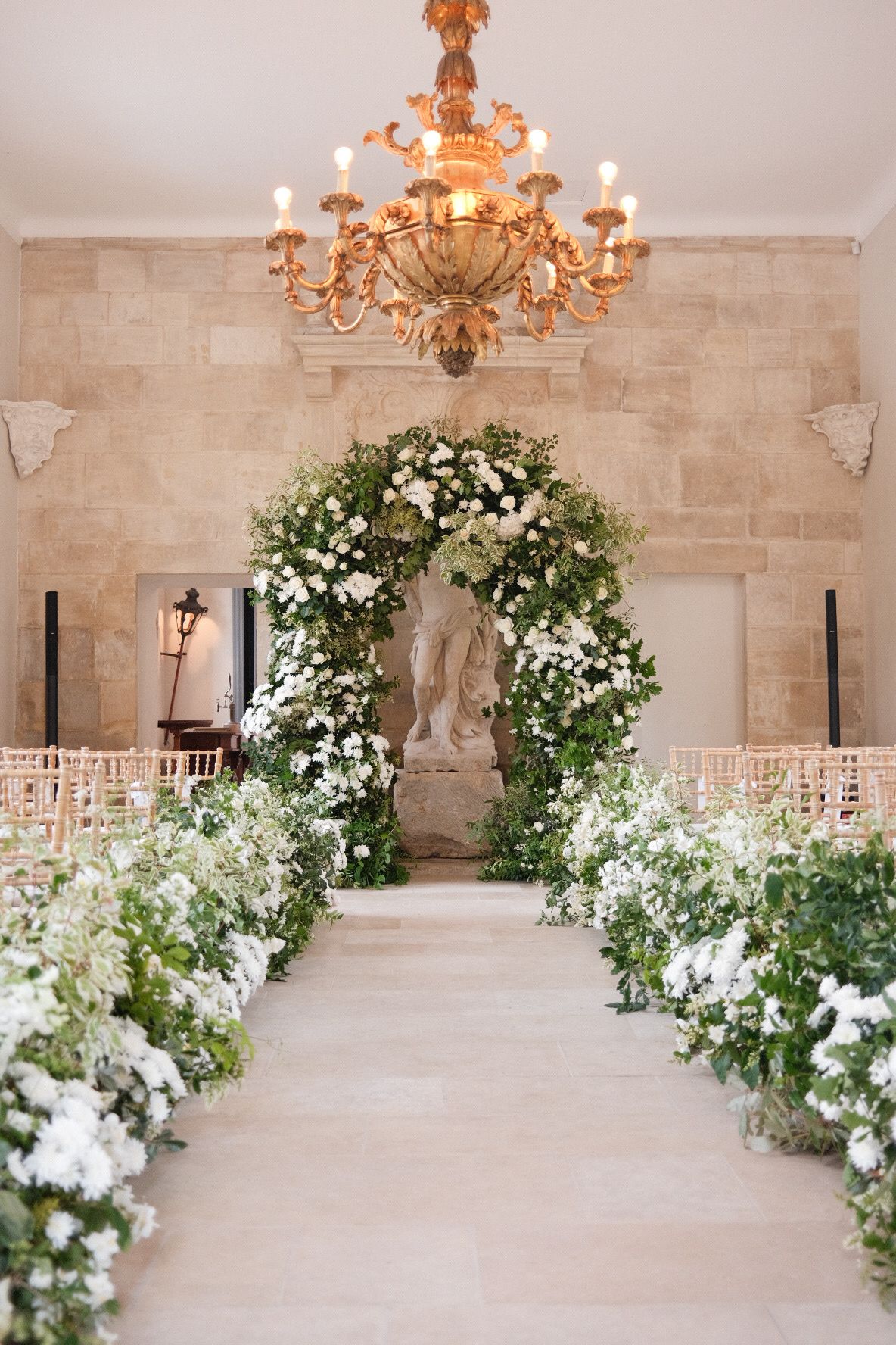 Green and white floral arch ceremony installation in luxury Paris wedding at Chateau de Villette
