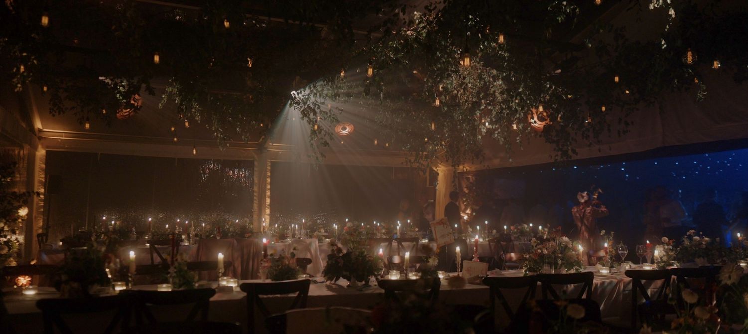 Moody wedding marquee tablescape during cocktail hour at luxury UK Cotswolds wedding
