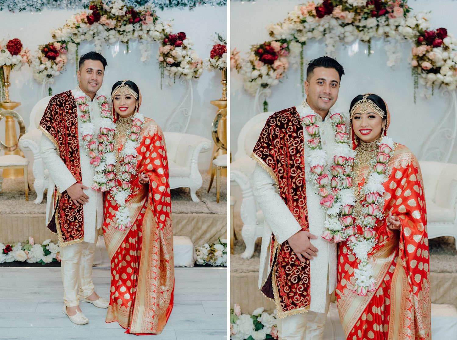 Couple in traditional red and white wedding attire posing against floral backdrop.