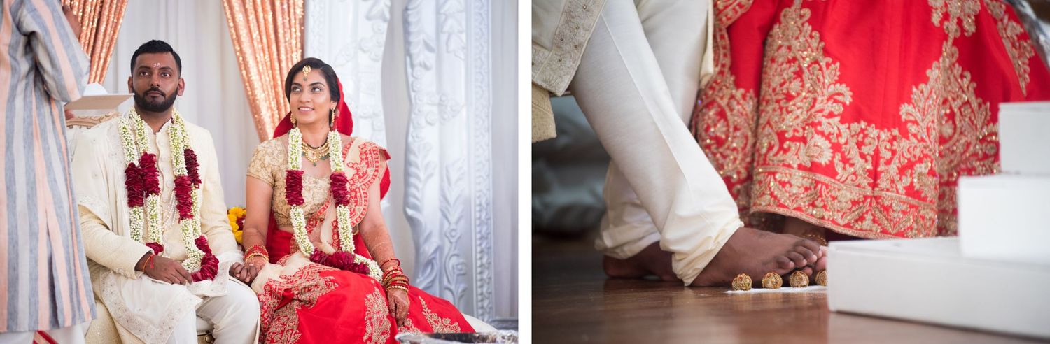 A wedding couple in traditional Indian attire seated against a backdrop with peach sequin curtains.