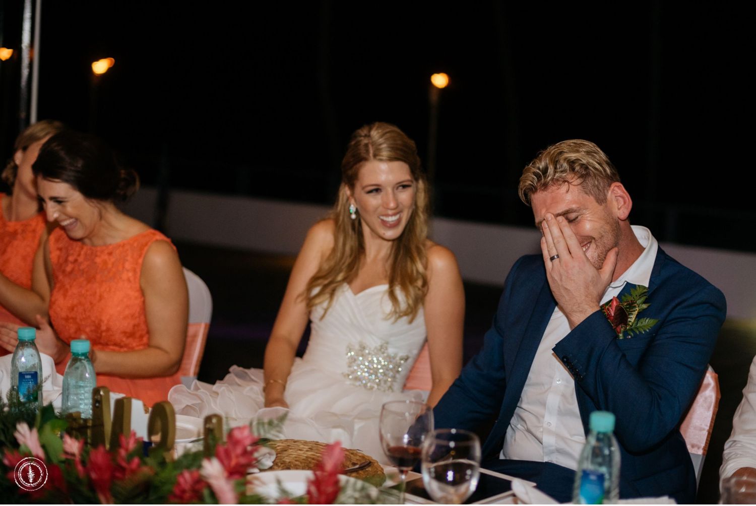An emotional moment captured during wedding speeches at an elegantly decorated reception dinner table.