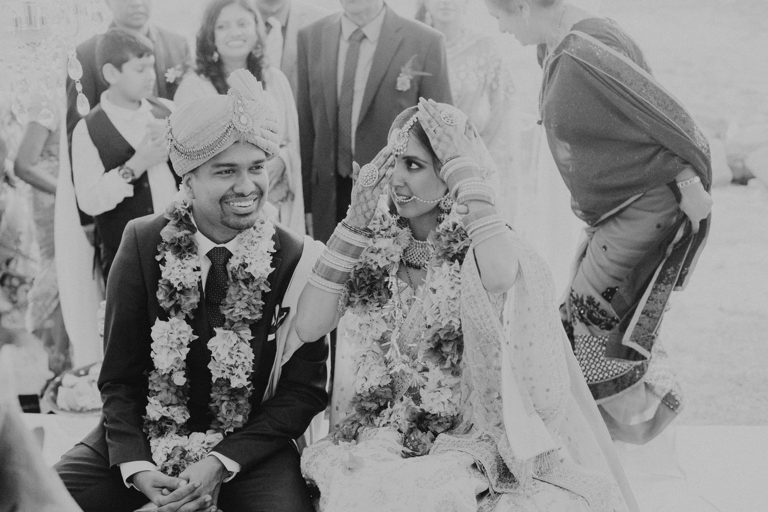 Black and white photograph of a couple during their traditional wedding ceremony.