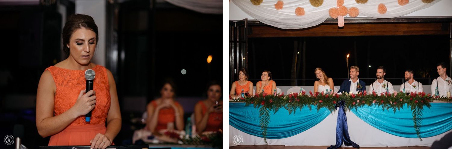 Wedding guests enjoy dinner and speeches under twinkling lights at a reception with bright turquoise decor.