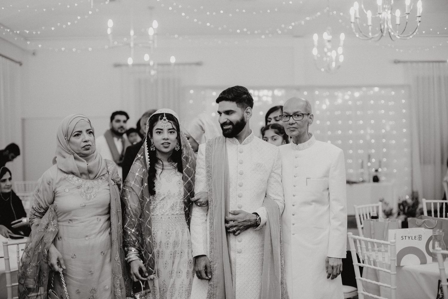 Traditional wedding celebration in monochrome with elegant white attire and modern decor.