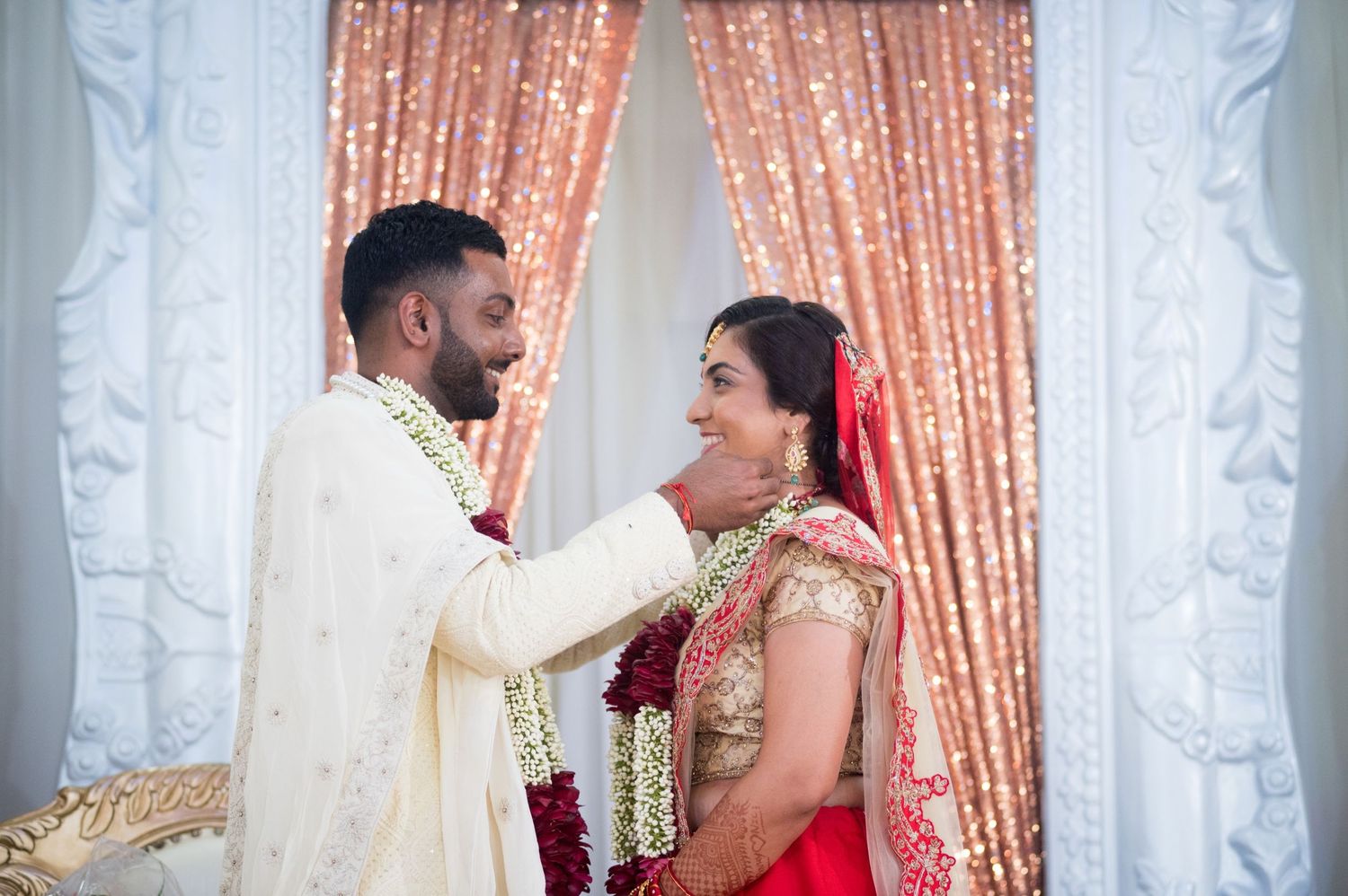 A tender moment between the couple during their Indian wedding ceremony.