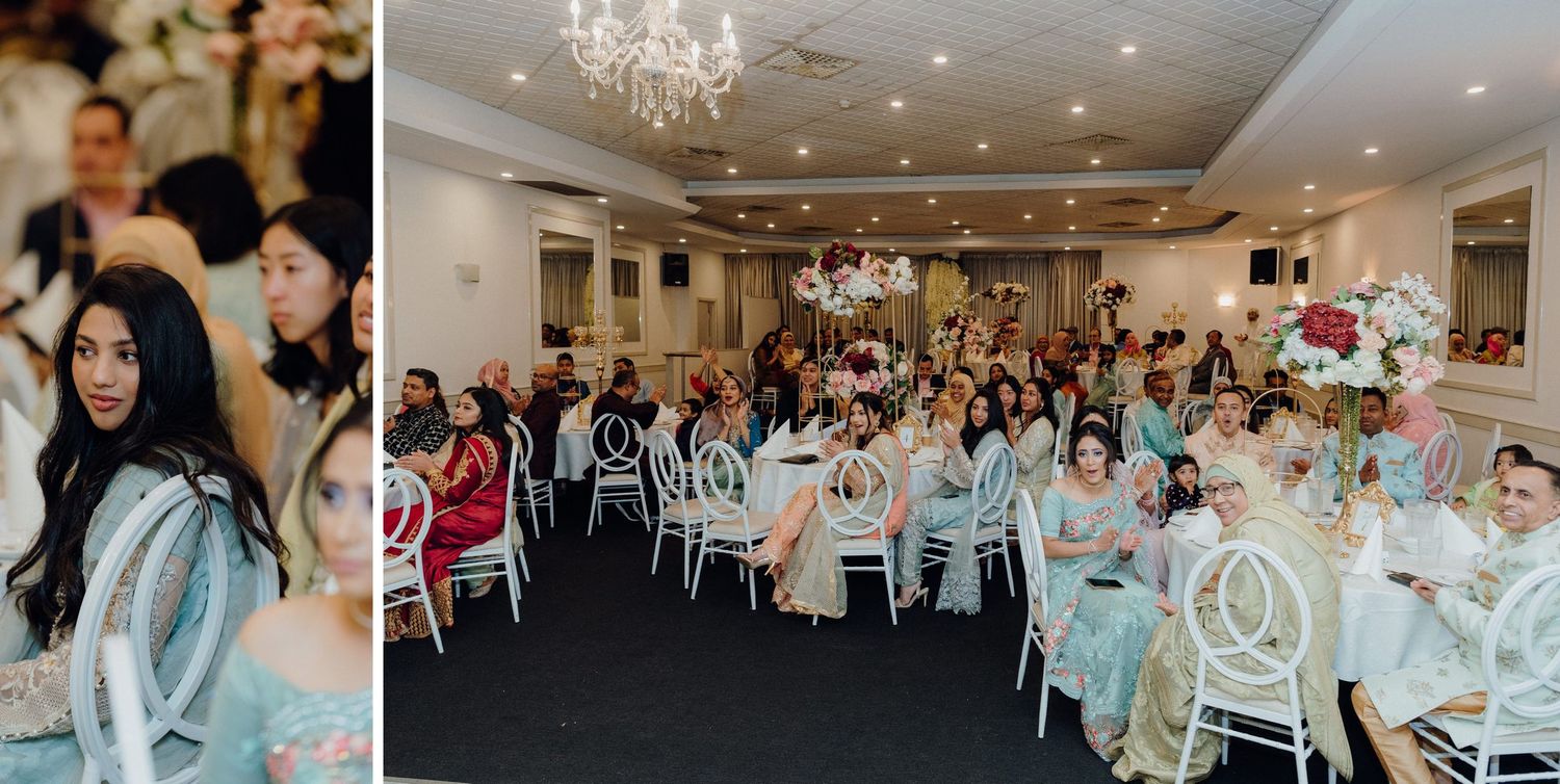Large wedding reception hall filled with guests at decorated tables under chandeliers.