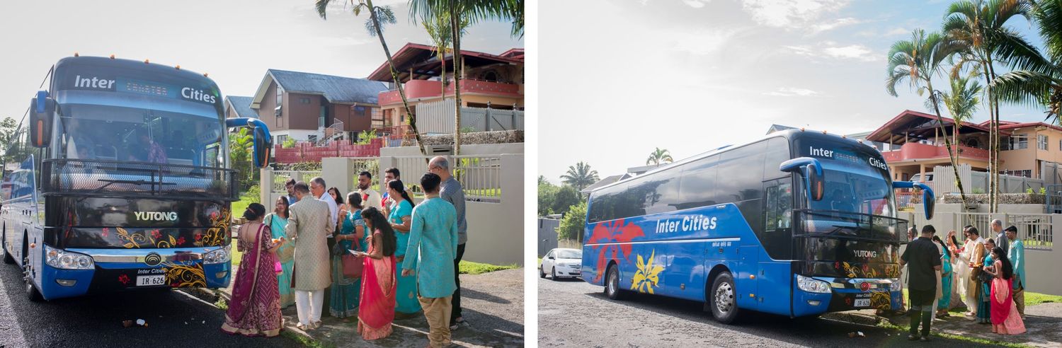 Blue tour buses parked with wedding guests in traditional attire boarding.