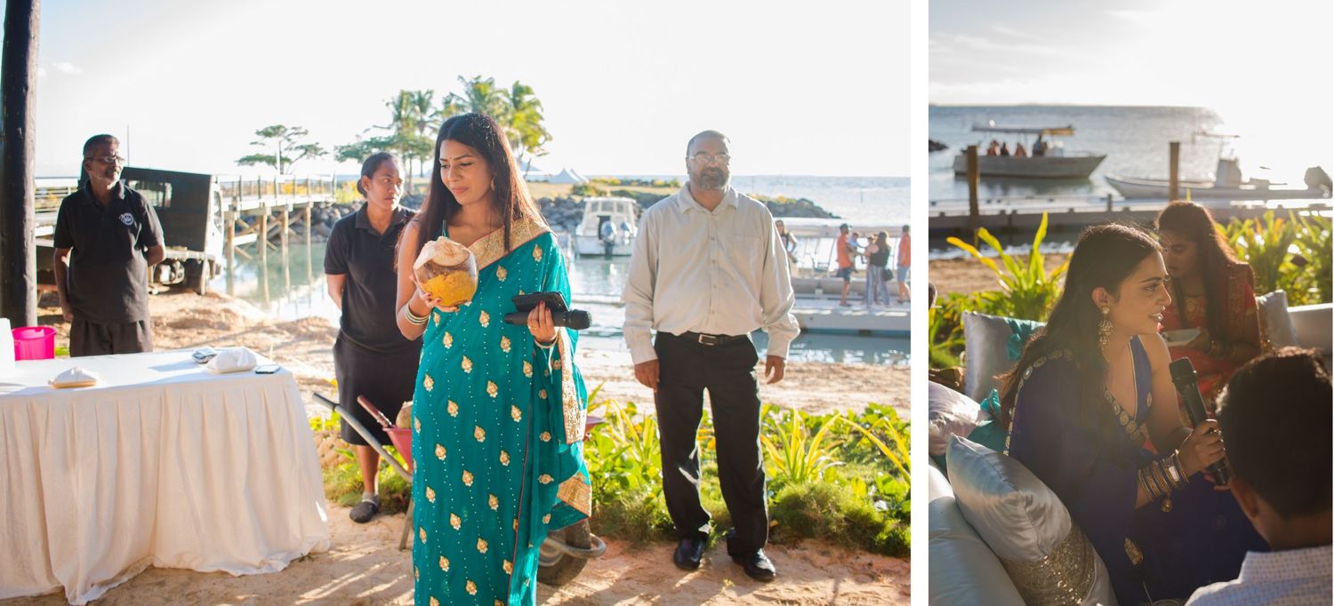 Guests in colorful attire enjoy an outdoor celebration near the water.