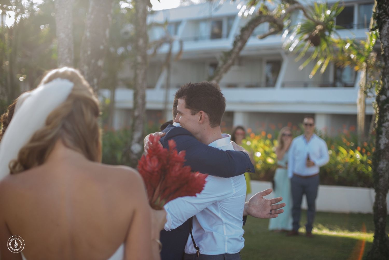Sunset wedding moment captured in a tropical garden setting.