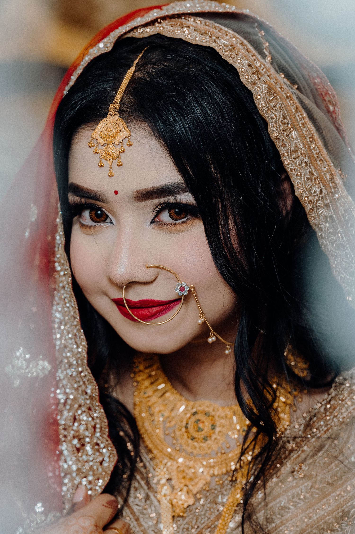Detailed shot of South Asian bridal look with traditional jewelry and makeup.