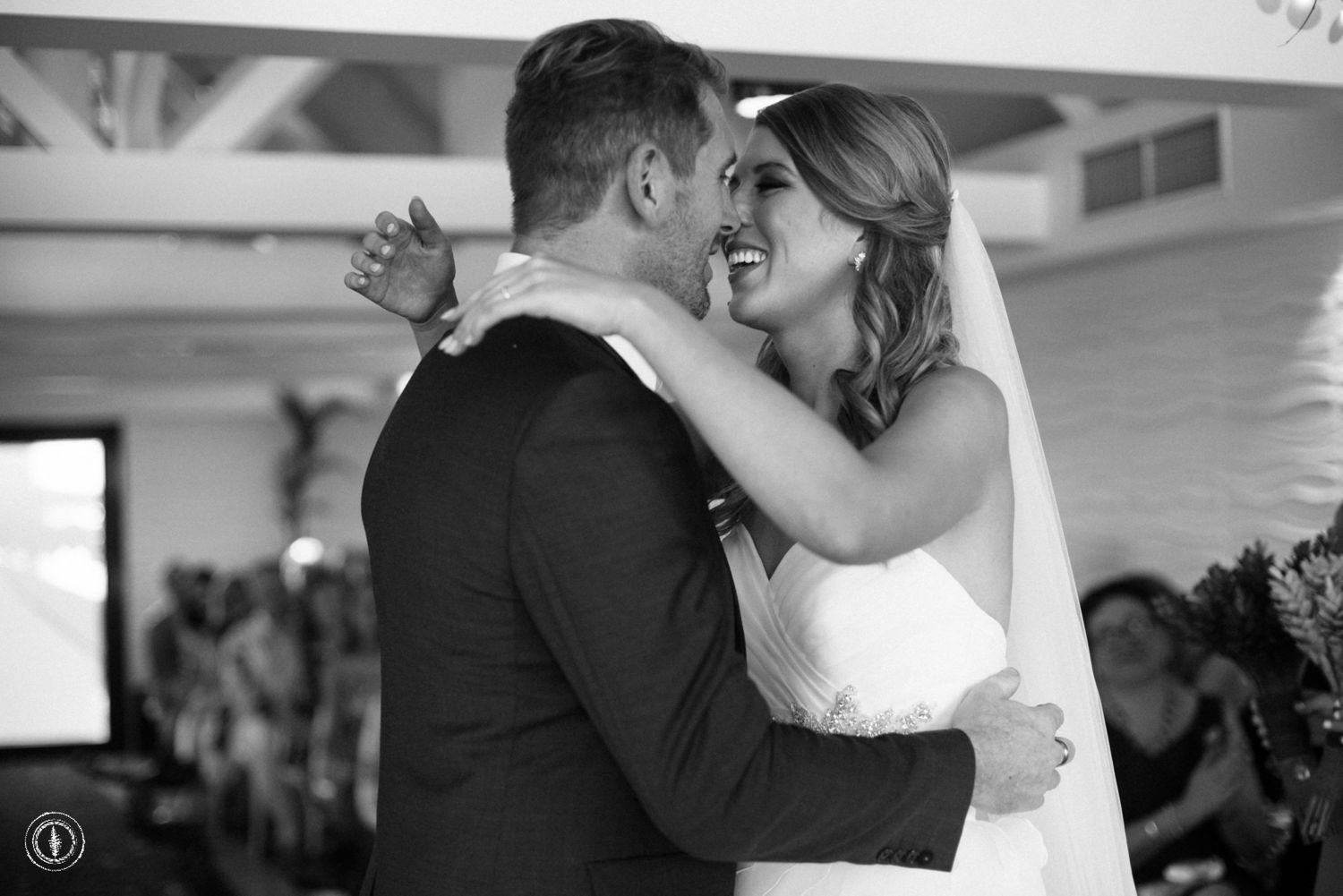 Intimate black and white moment shared during wedding ceremony.