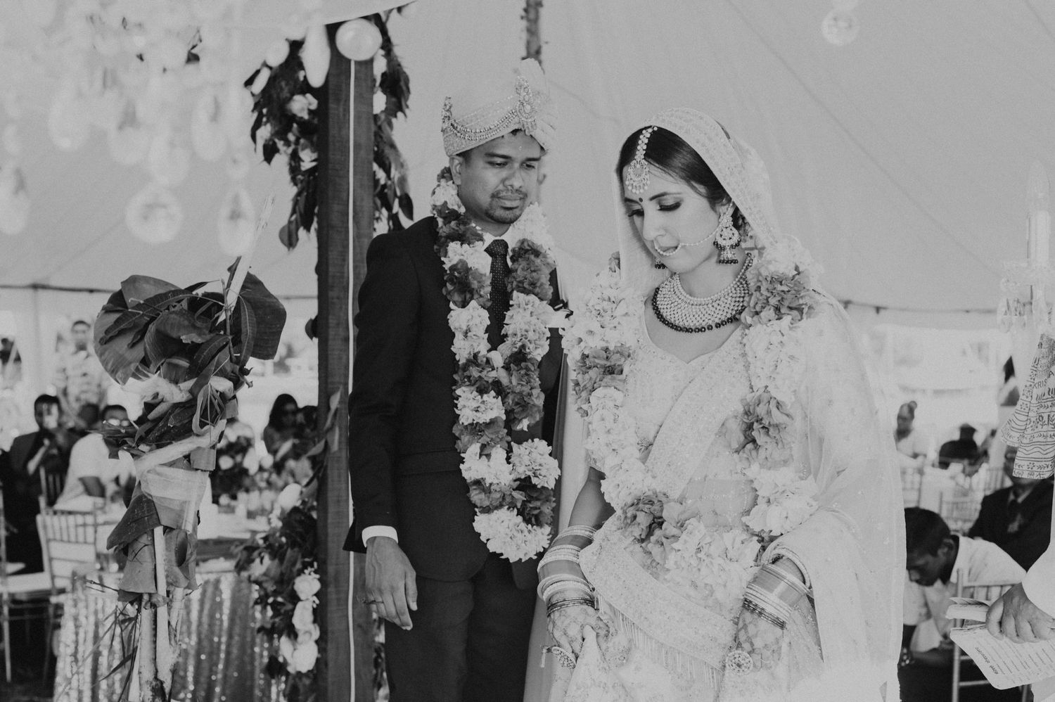 Black and white photo of a couple during their traditional wedding ceremony.