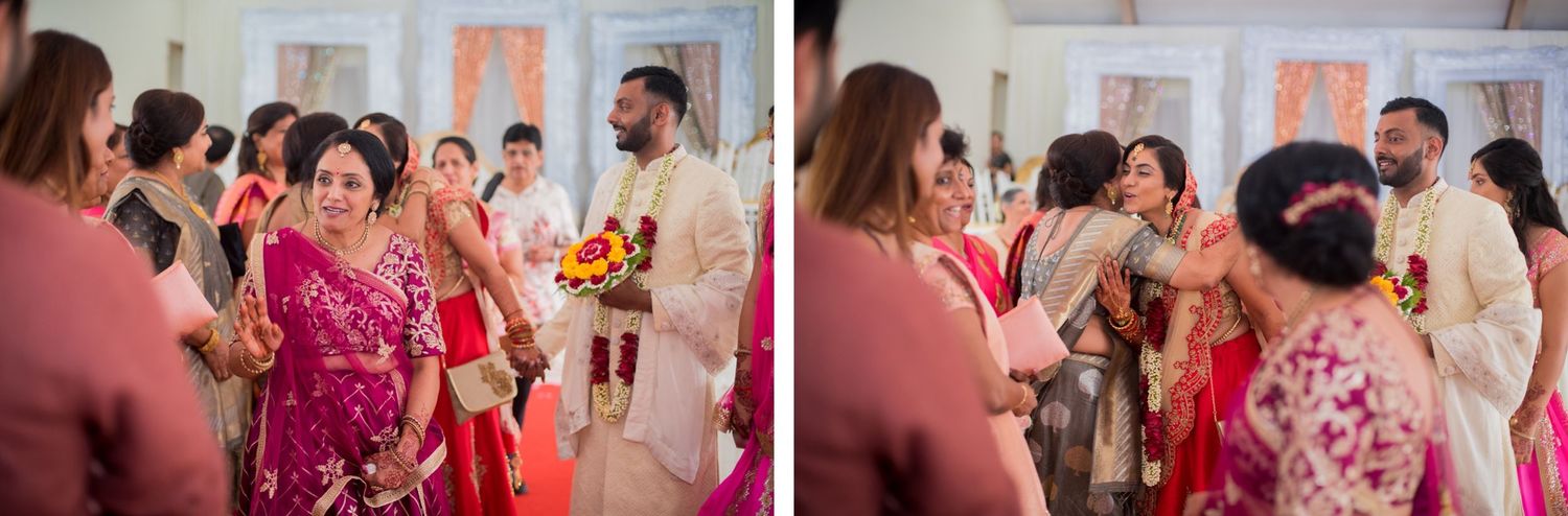 Colorful celebration scene with guests in traditional Indian wedding attire mingling indoors.