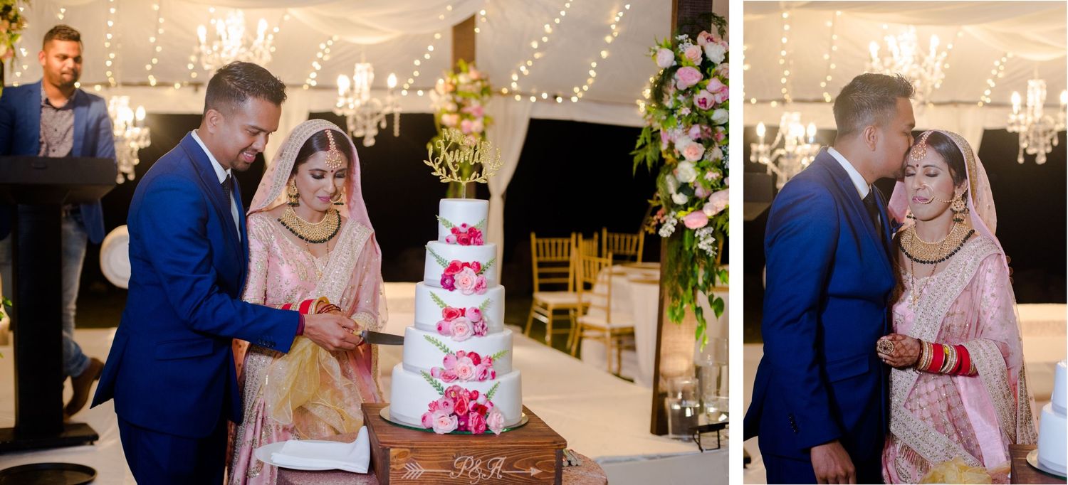 Couple cuts their pink and white tiered wedding cake during reception celebration.