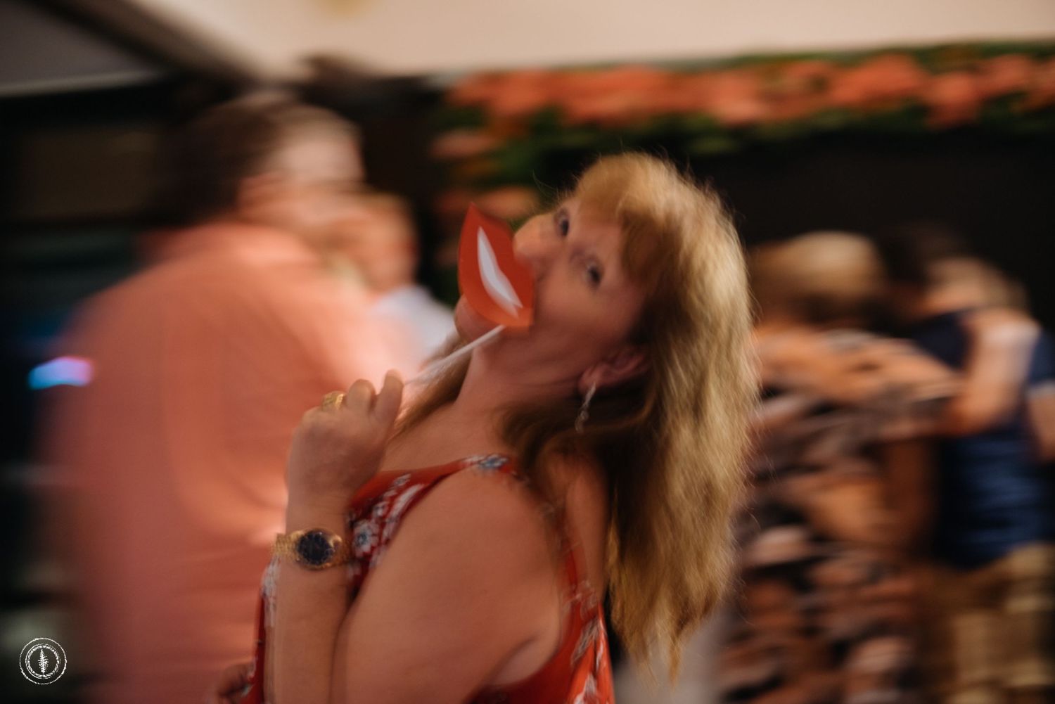 A guest dancing enthusiastically at a wedding reception with motion blur effect.