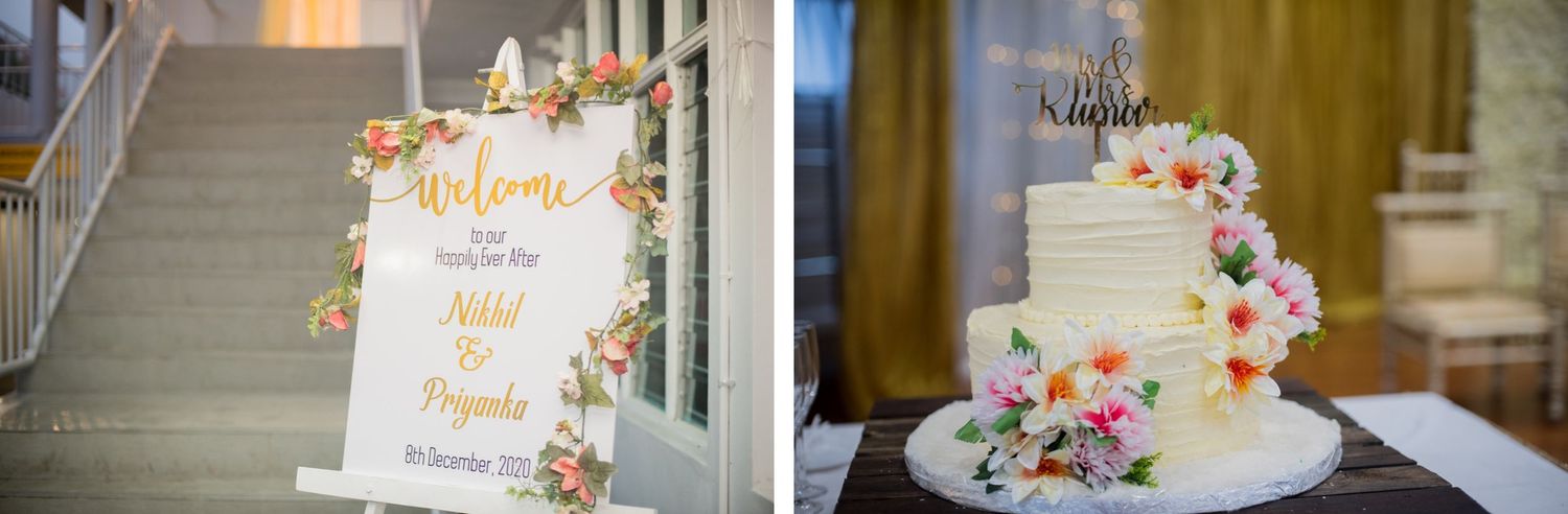 Wedding welcome sign and three-tiered white cake decorated with fresh flowers.