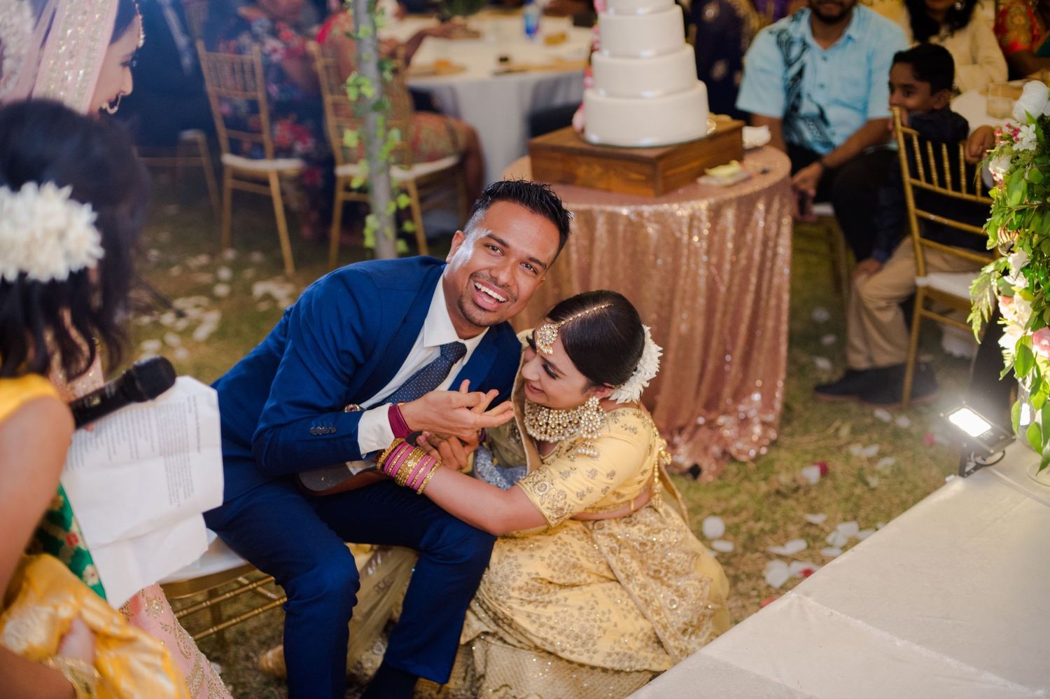 Joyful moment shared during wedding reception with festive decorations.