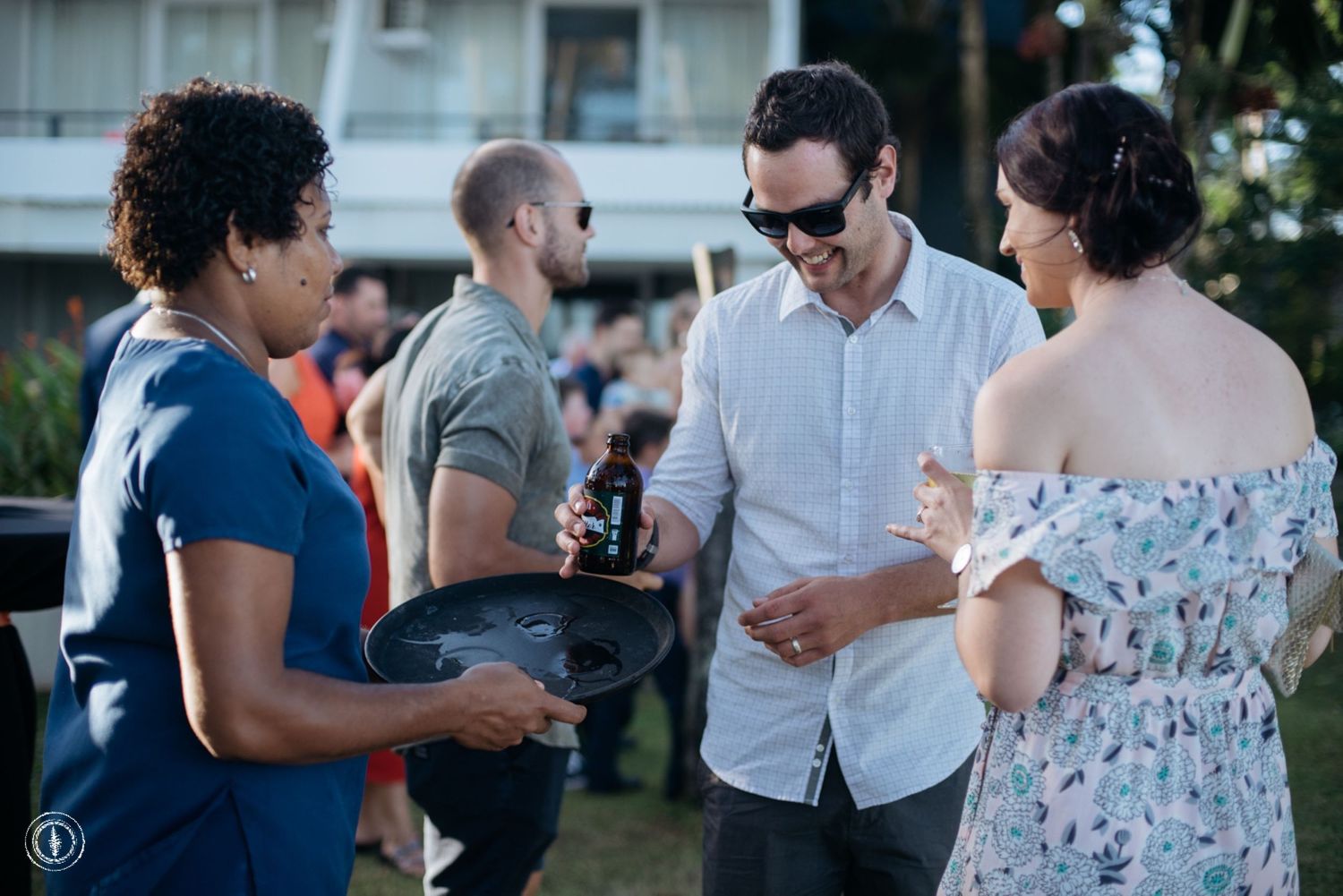 Small group of guests chatting during an outdoor cocktail reception.