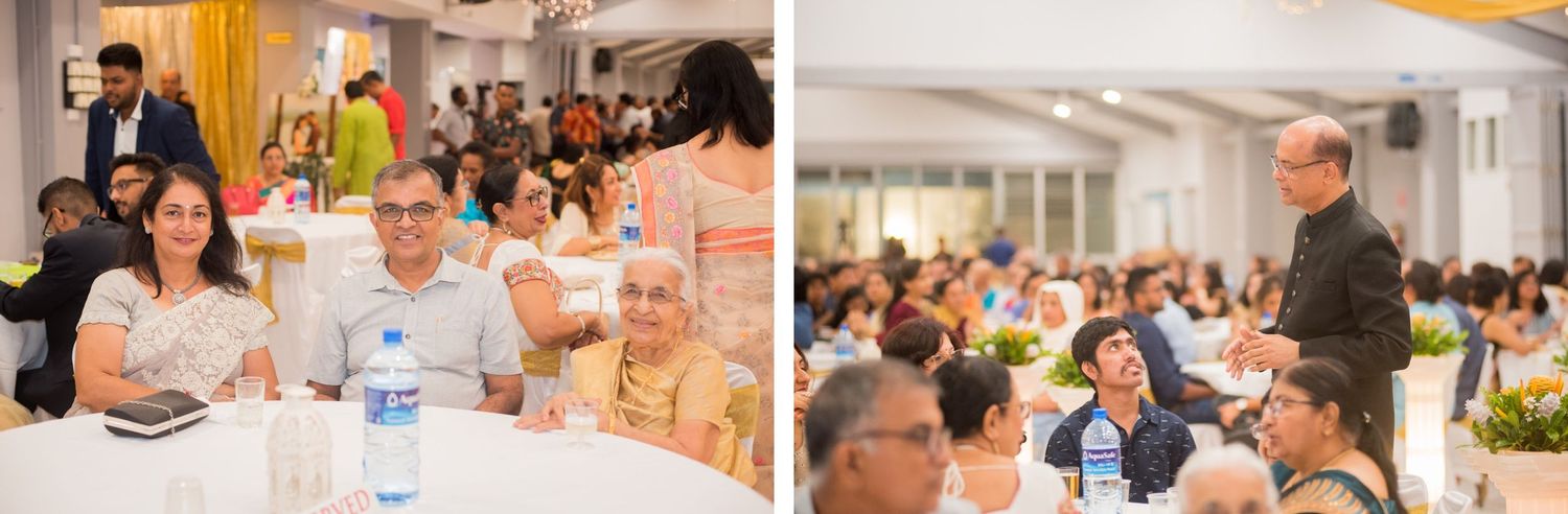 Large reception hall filled with guests during formal dinner event.