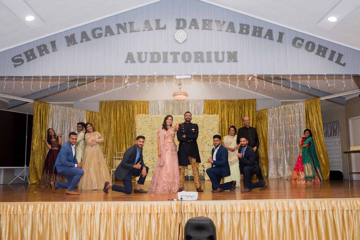 Group photo on stage at Shri Maganlal Daeyabhai Gohil Auditorium.