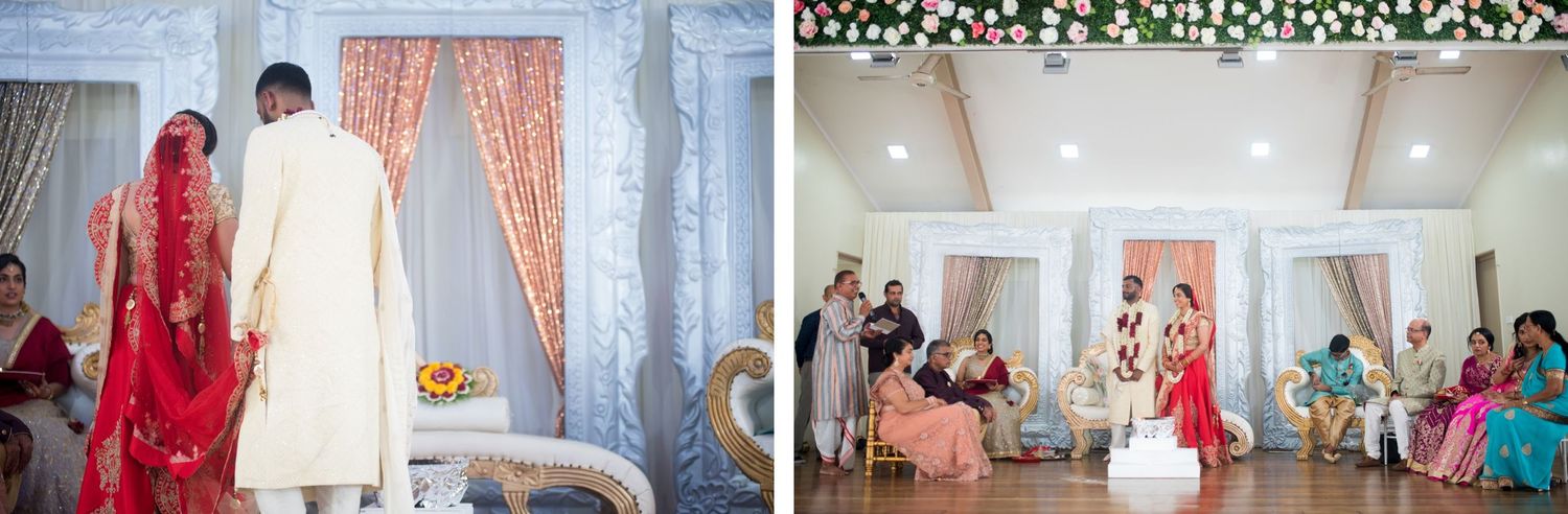 Wedding guests gather in an elegant venue with white floral decor and peach drapery.
