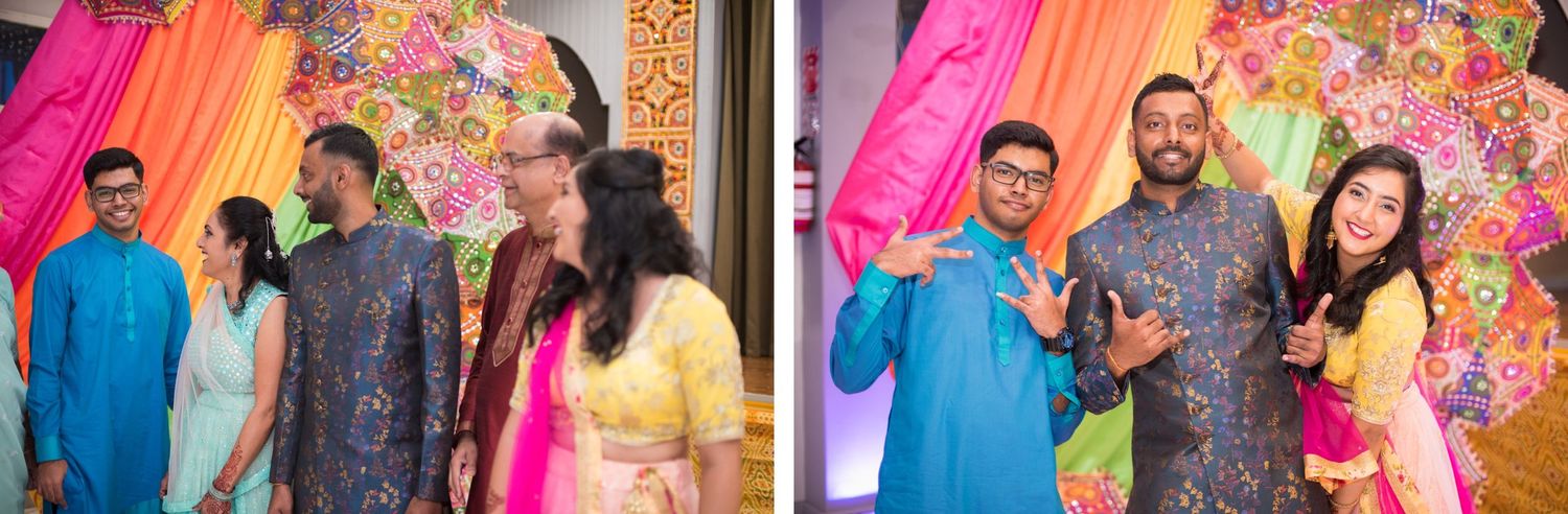 Guests mingling at a colorful Indian celebration with floral backdrop and traditional outfits.