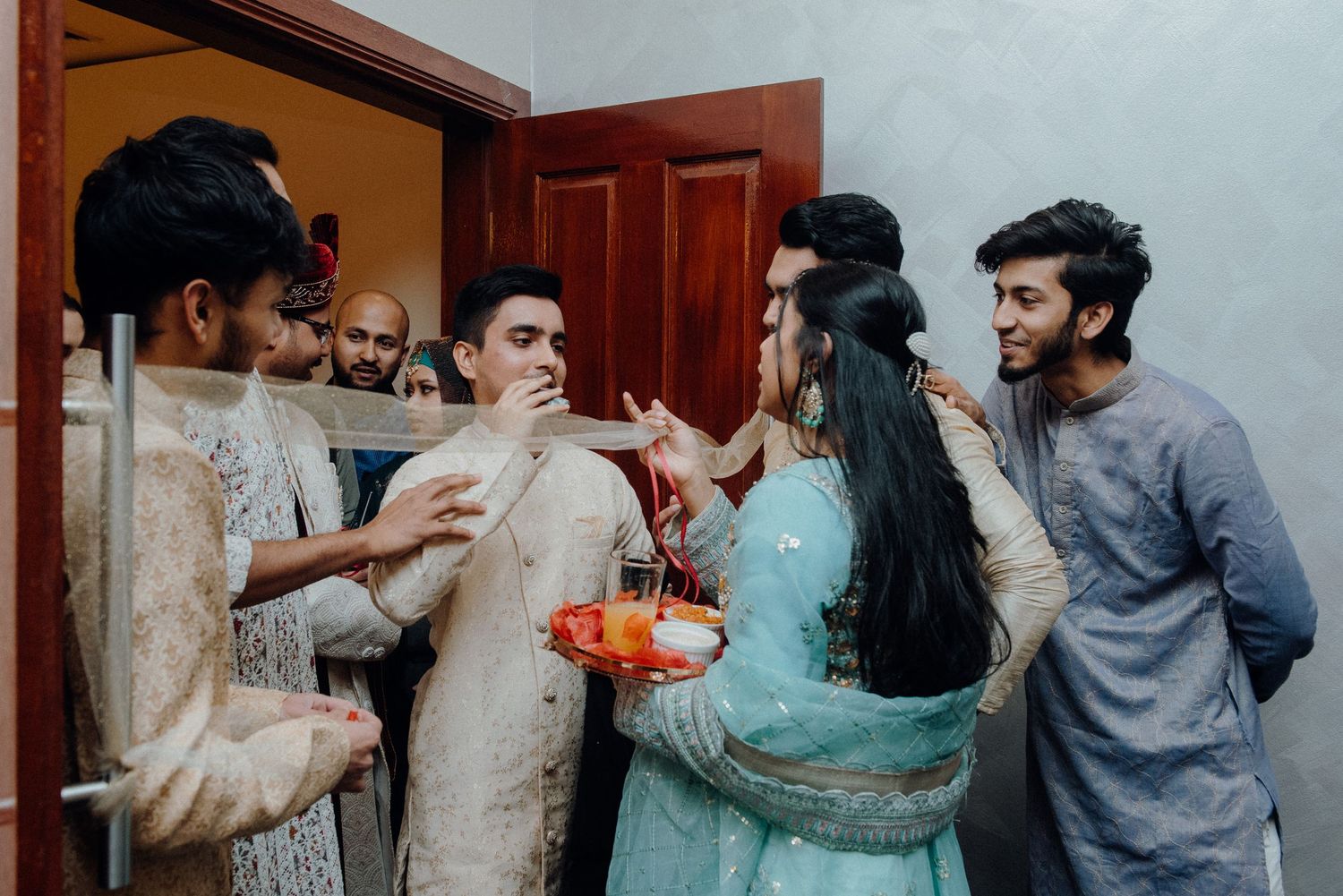 Wedding guests participate in traditional celebrations with treats and refreshments.