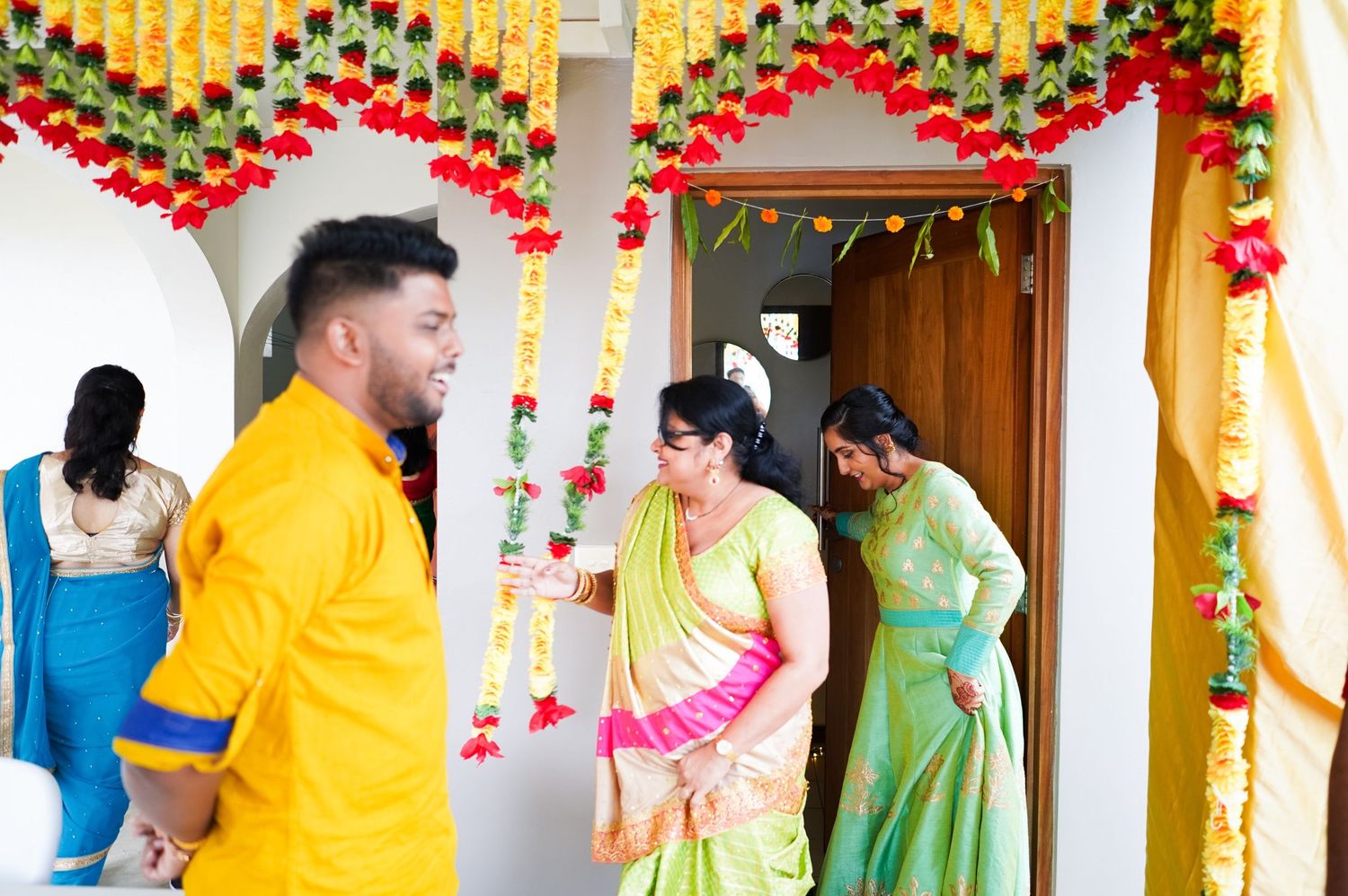 Festive doorway decorated with yellow and red flower garlands for an Indian celebration.