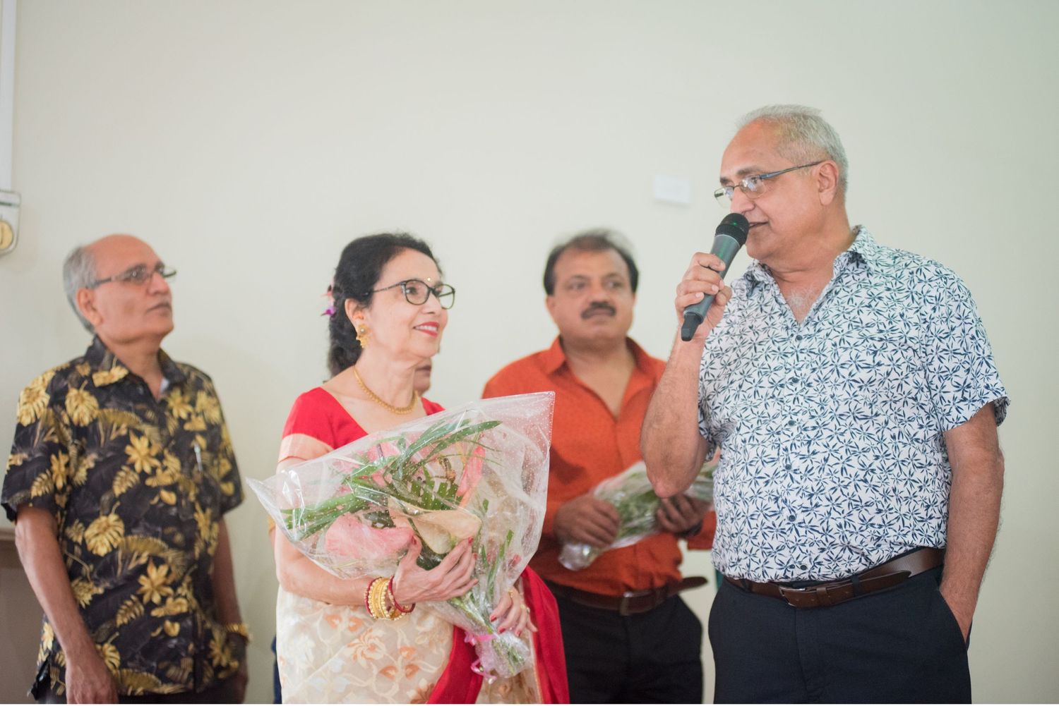 Group gathered for speech during wedding reception event.