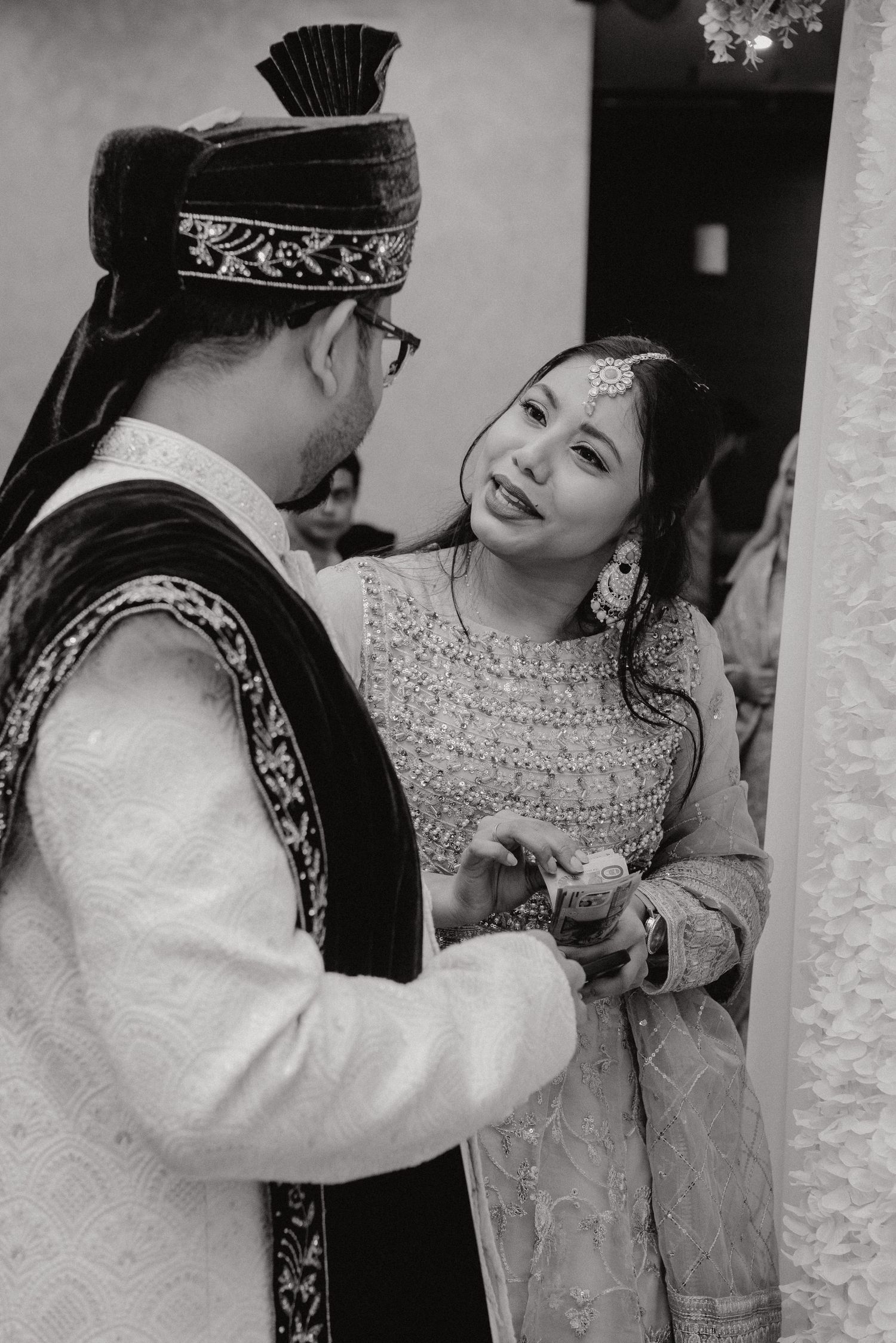A black and white capture of a tender moment during a South Asian wedding ceremony.
