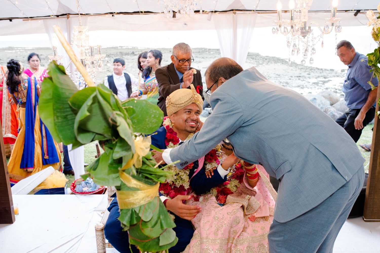 Wedding celebration scene with colorful decorations and guests interacting.