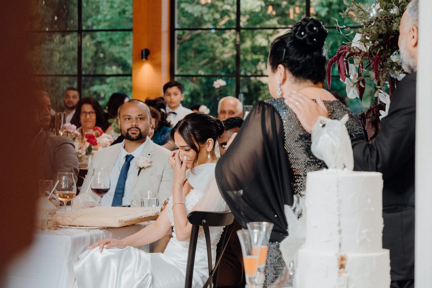 Reception guests gathered at tables while listening to wedding speeches.