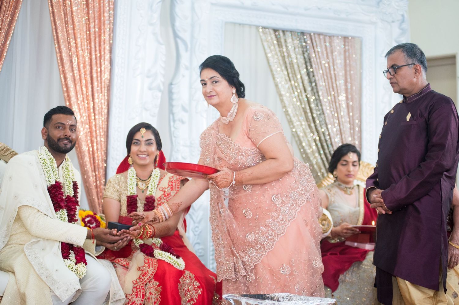 Traditional Indian wedding ceremony with family members participating in rituals.