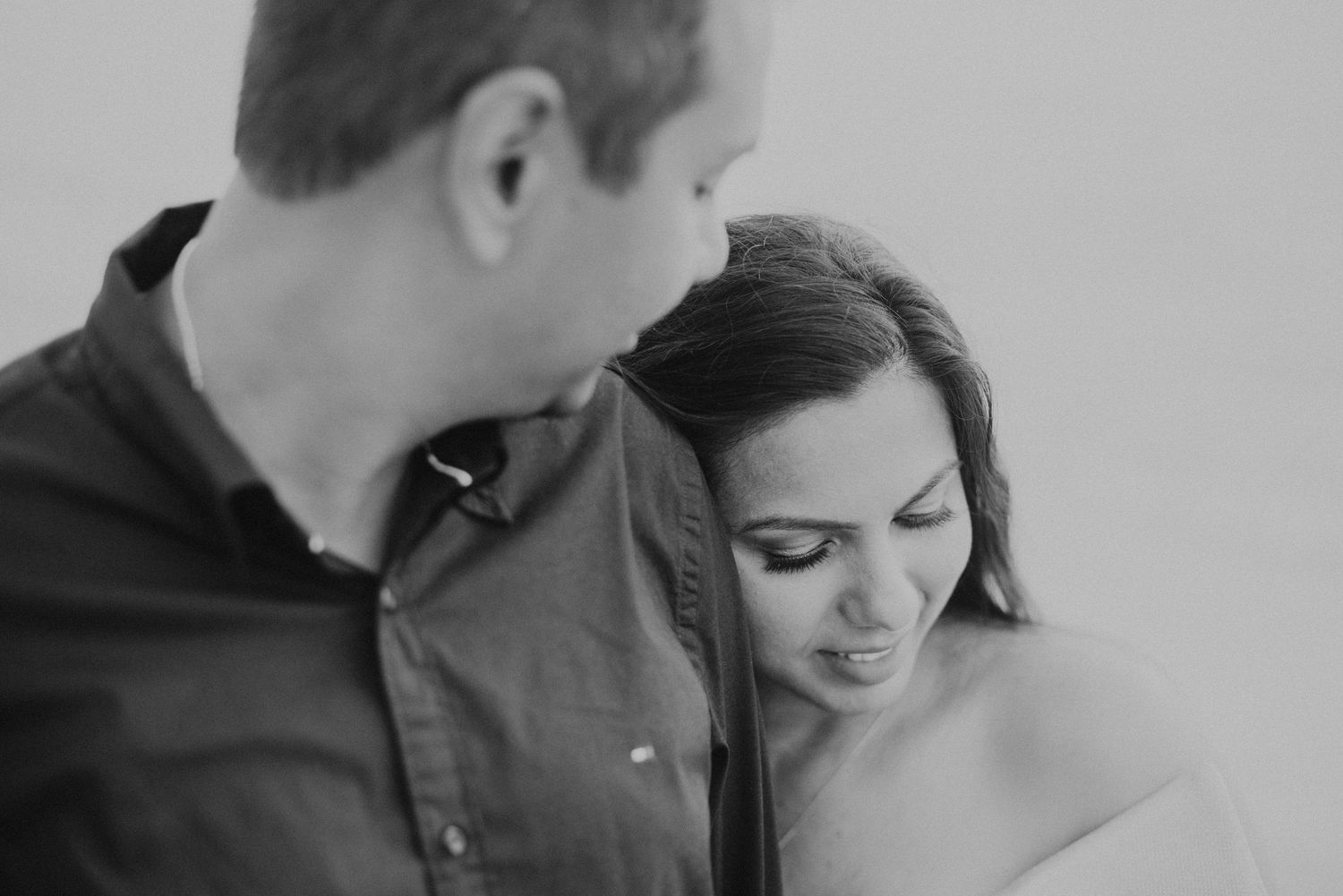 Intimate black and white portrait of a couple sharing a tender close moment together.