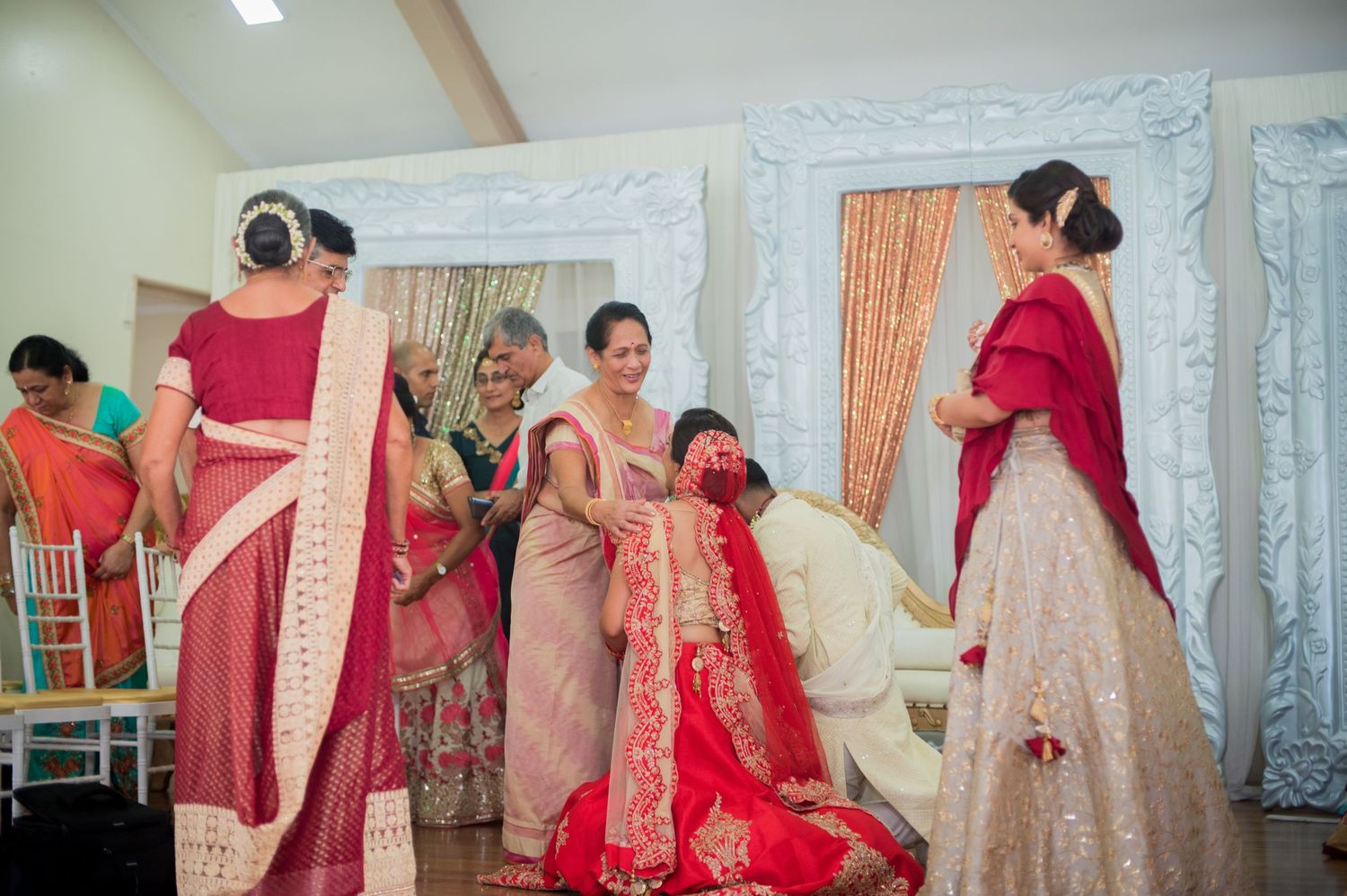 Traditional South Asian wedding ceremony moment with guests in colorful attire.